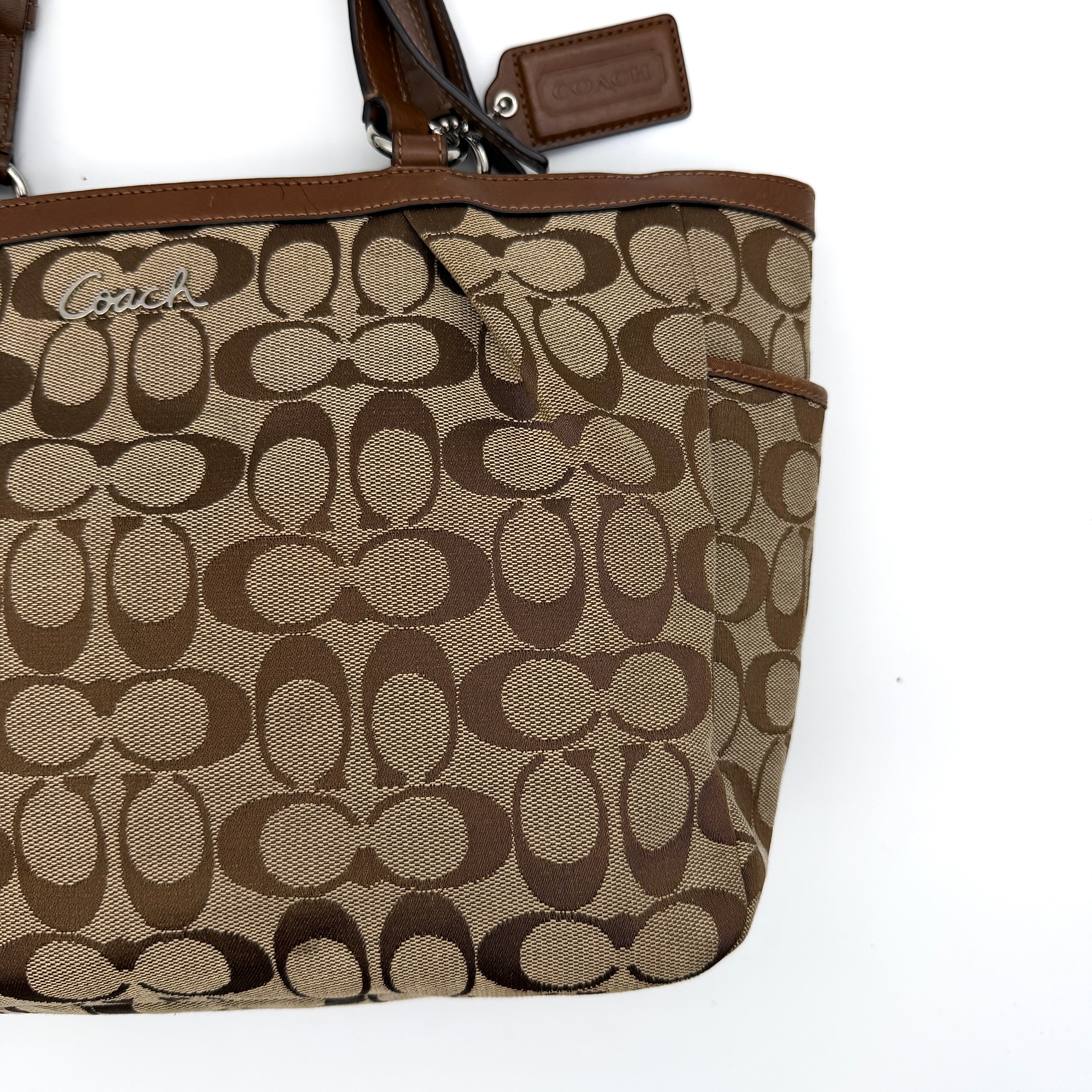 Coach Signature Gallery Tote Bag in beige and brown with double leather handles and the iconic logo pattern.