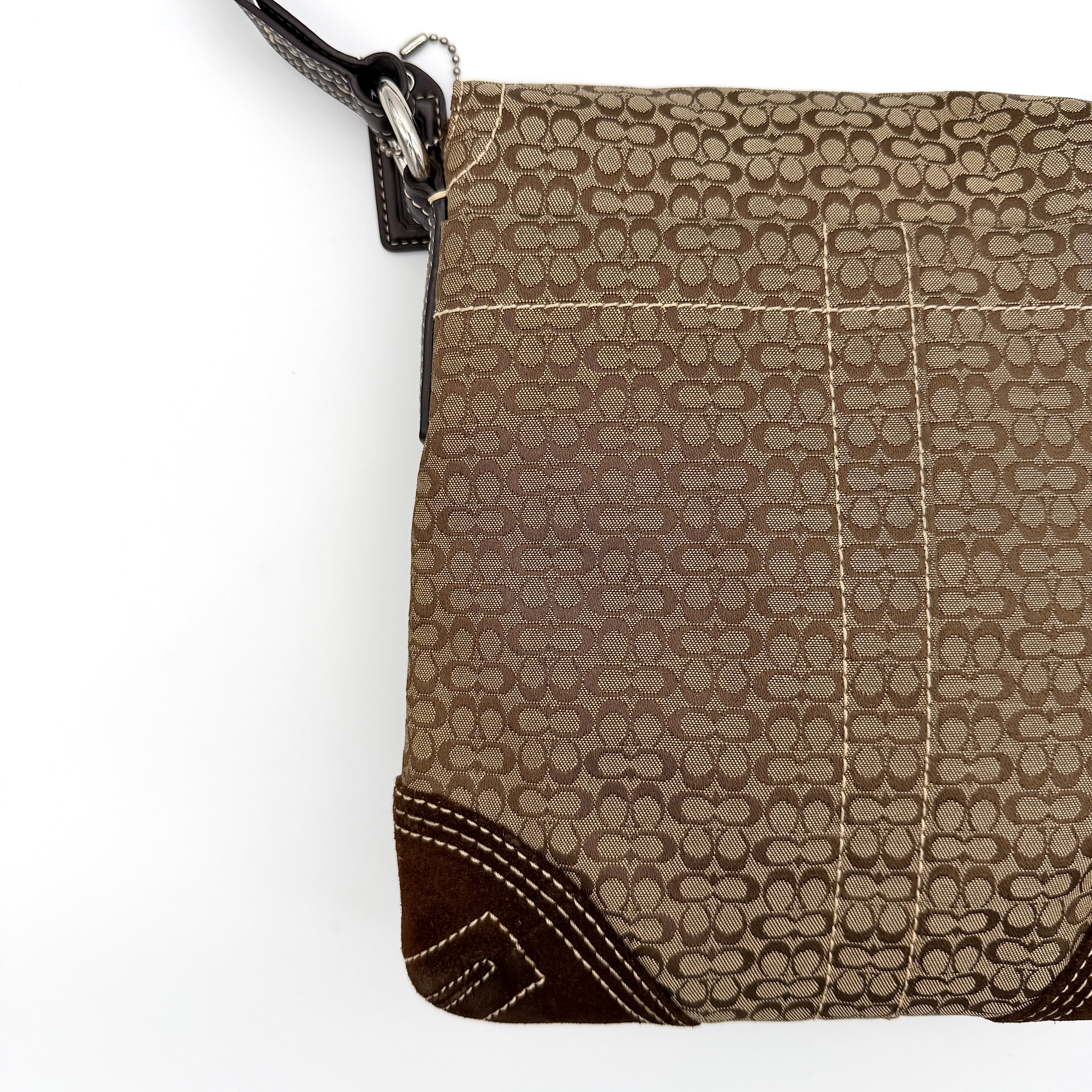 Coach Signature Soho Flap Crossbody Bag in brown jacquard canvas with suede trim and silver buckle, shown with adjustable strap.