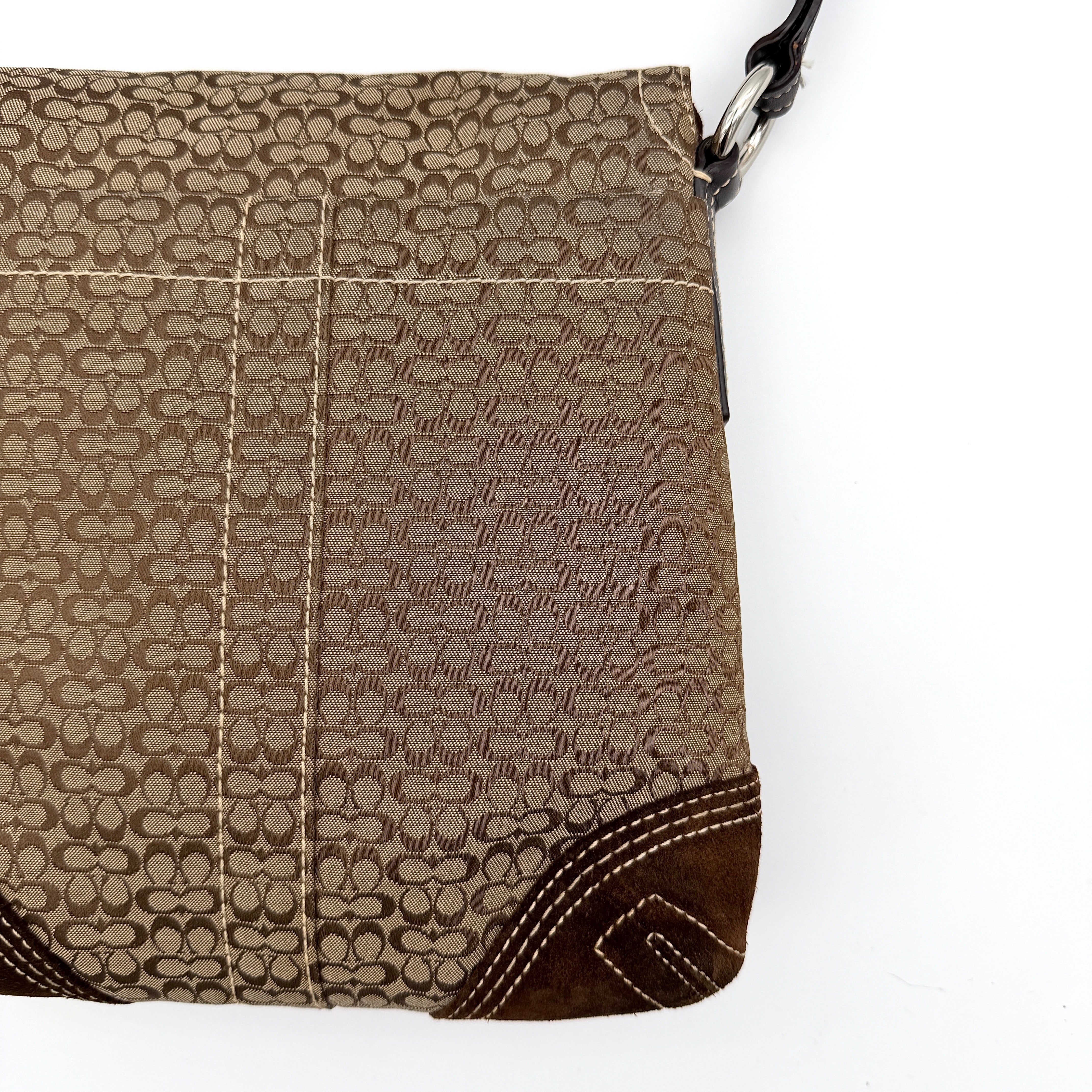 Coach Signature Soho Flap Crossbody Bag in brown jacquard canvas with suede trim and silver buckle, shown with adjustable strap.