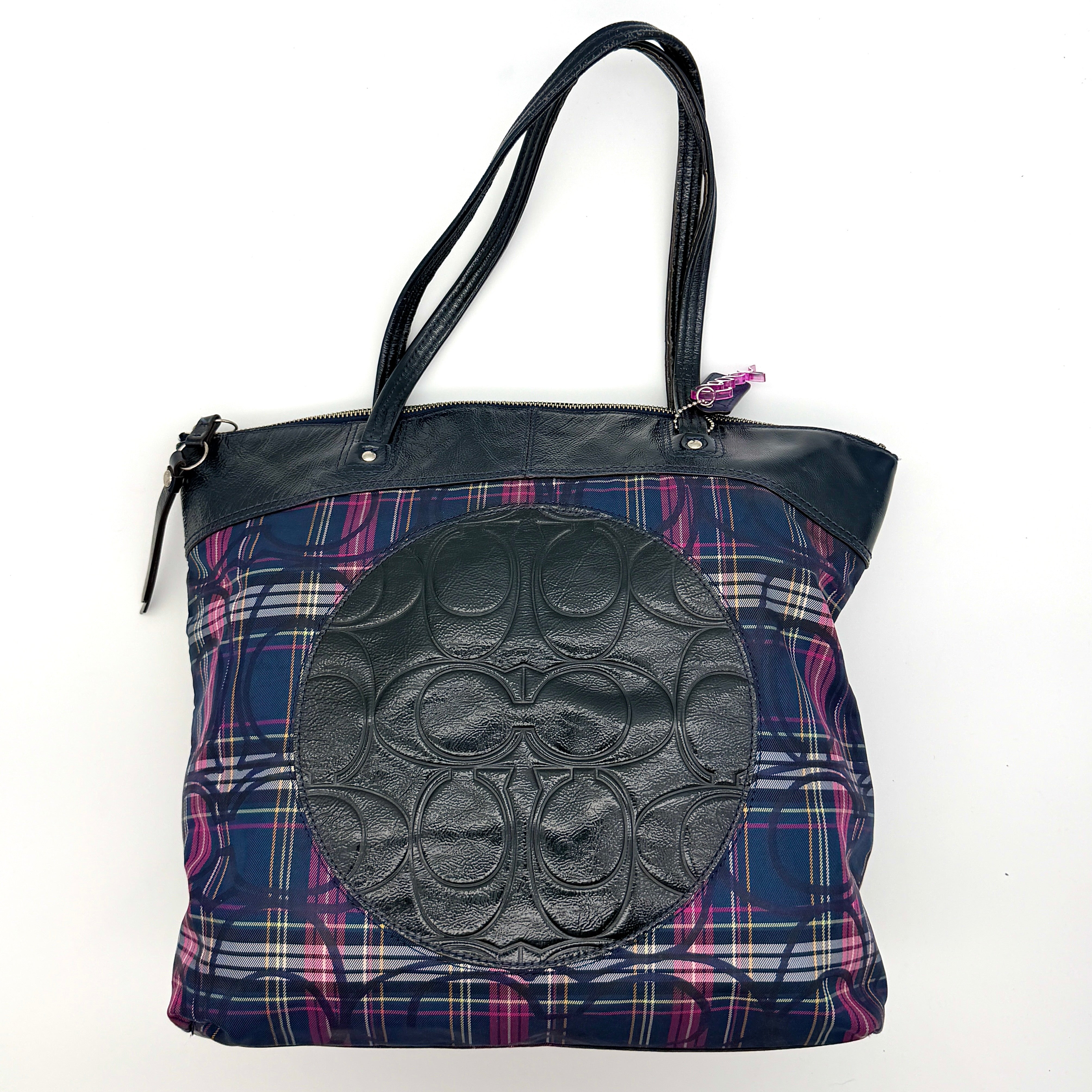 Coach Signature Tartan Plaid Tote Bag in navy, pink and yellow plaid with embossed leather circle and black leather trim.