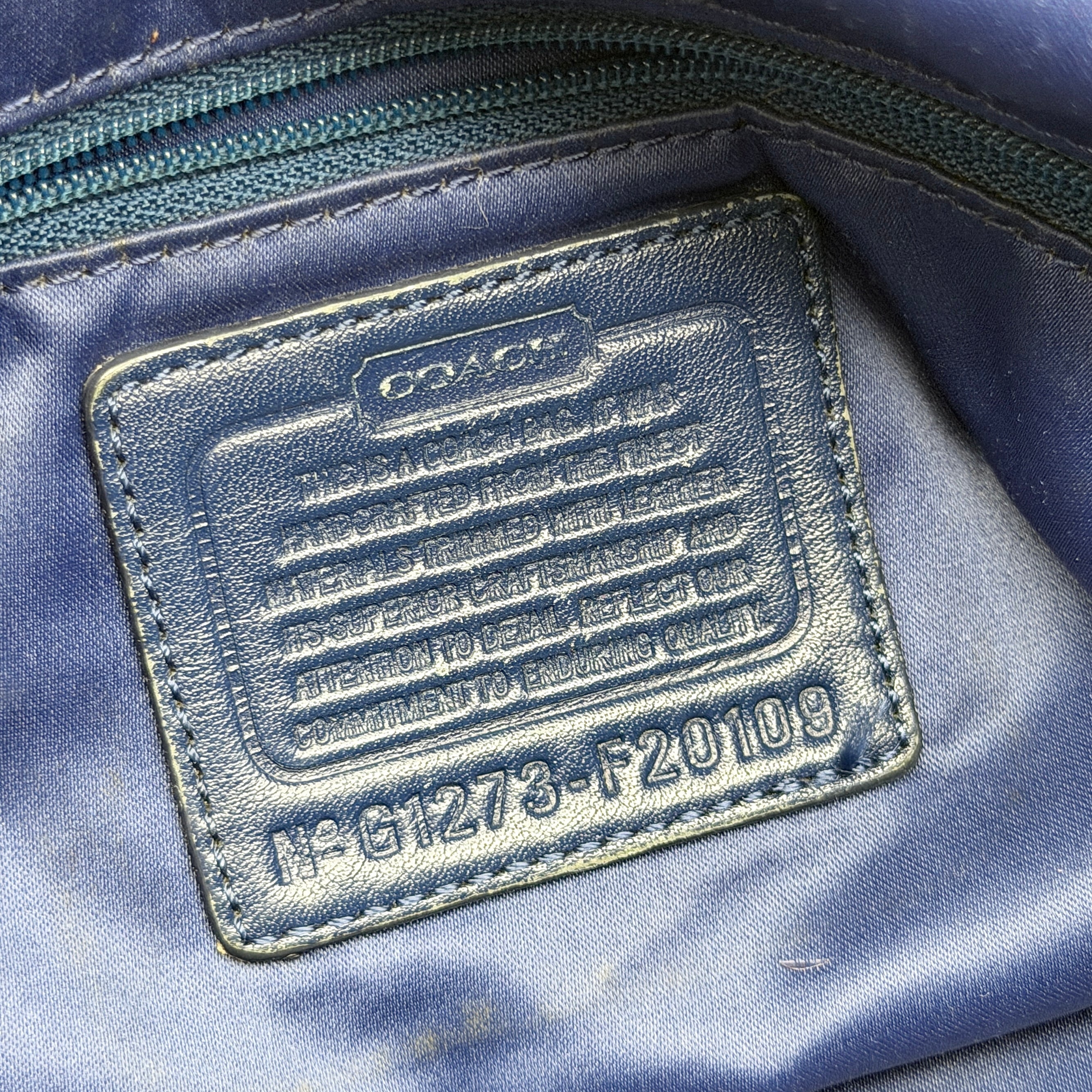 Coach Signature Tartan Plaid Tote Bag in navy, pink and yellow plaid with embossed leather circle and black leather trim.
