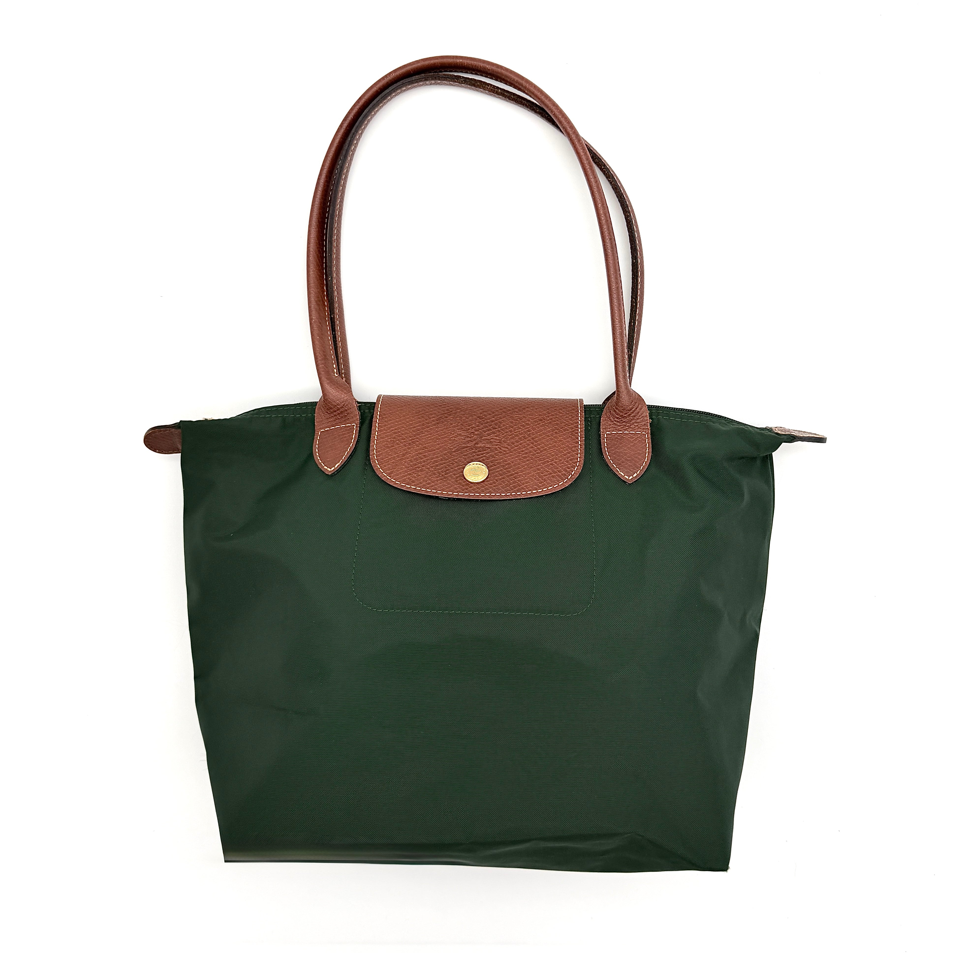 Longchamp Le Pliage Original Tote in green nylon with brown leather handles and gold hardware displayed against a white background.