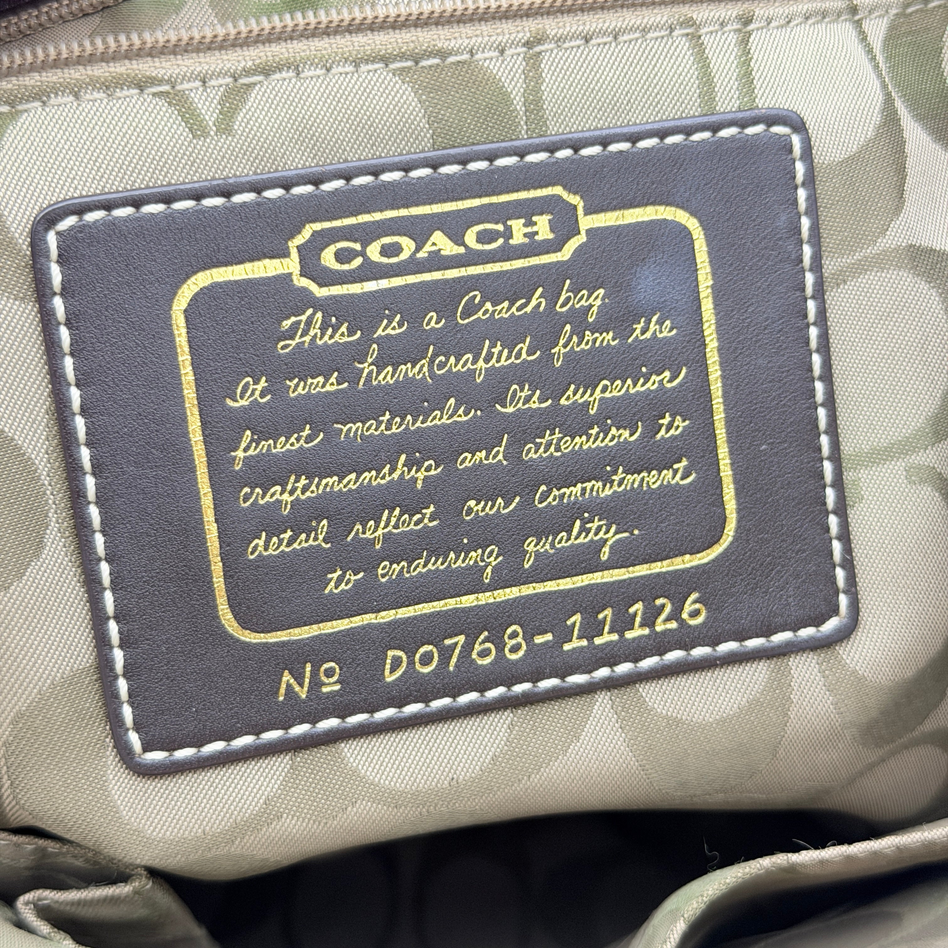 Coach Legacy Stripe Tote Bag in multicolour stripes with gold leather trim and double handles, displayed against a white background.