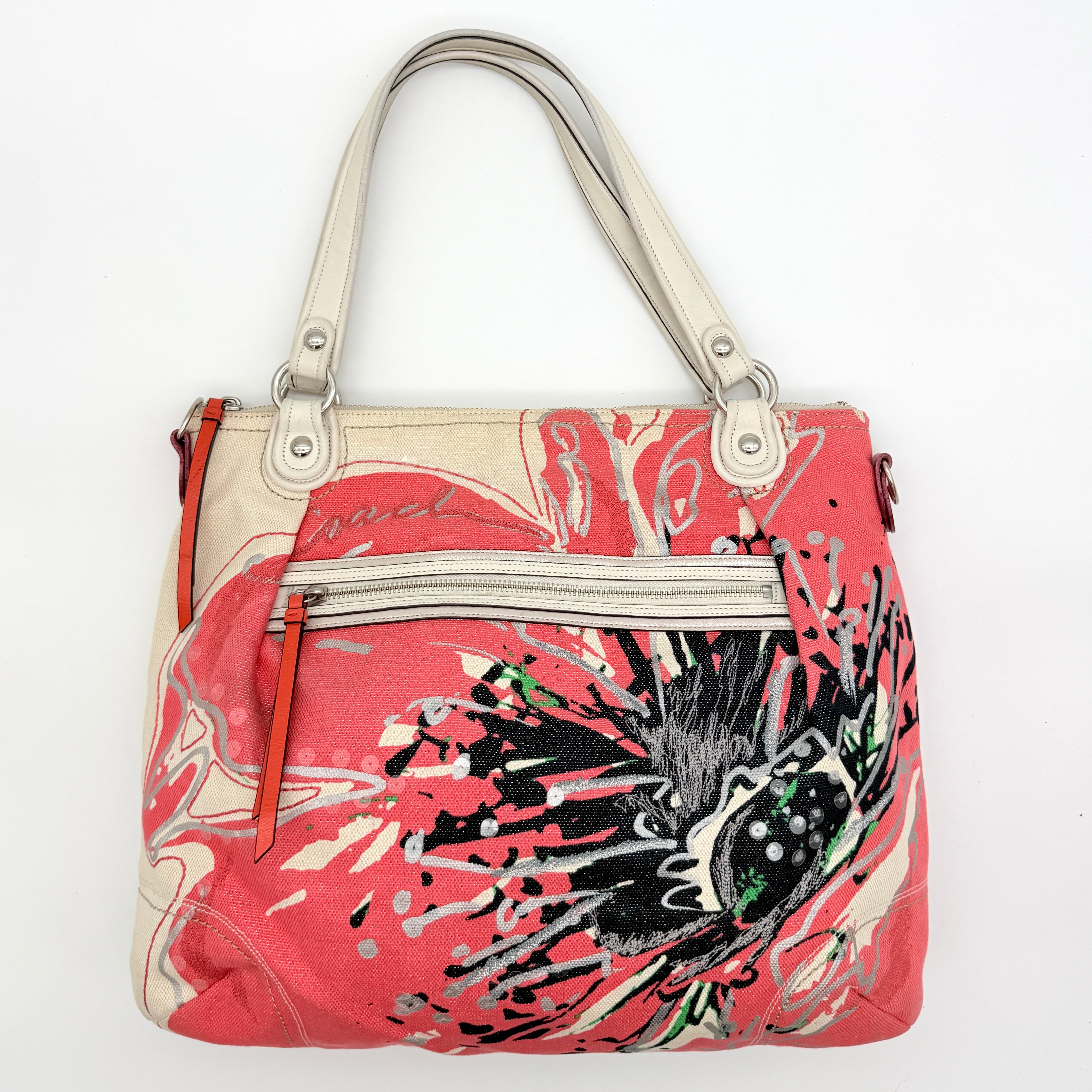 Coach Poppy Glam Floral Shoulder Bag in canvas with a bold multicolour floral print and cream leather handles, photographed on white.