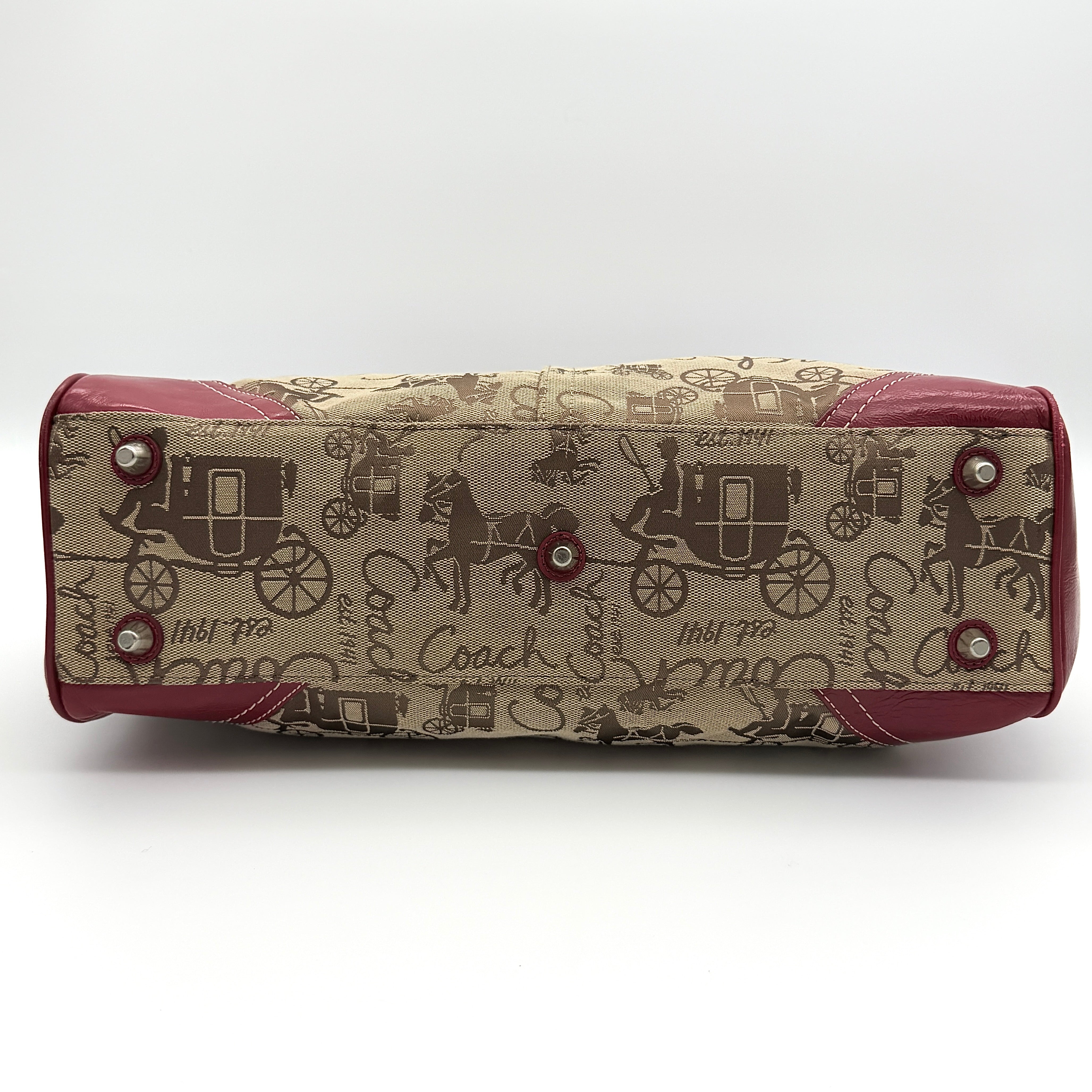 Coach Hampton Carryall in beige canvas with horse carriage motif, red leather trim, and double handles.