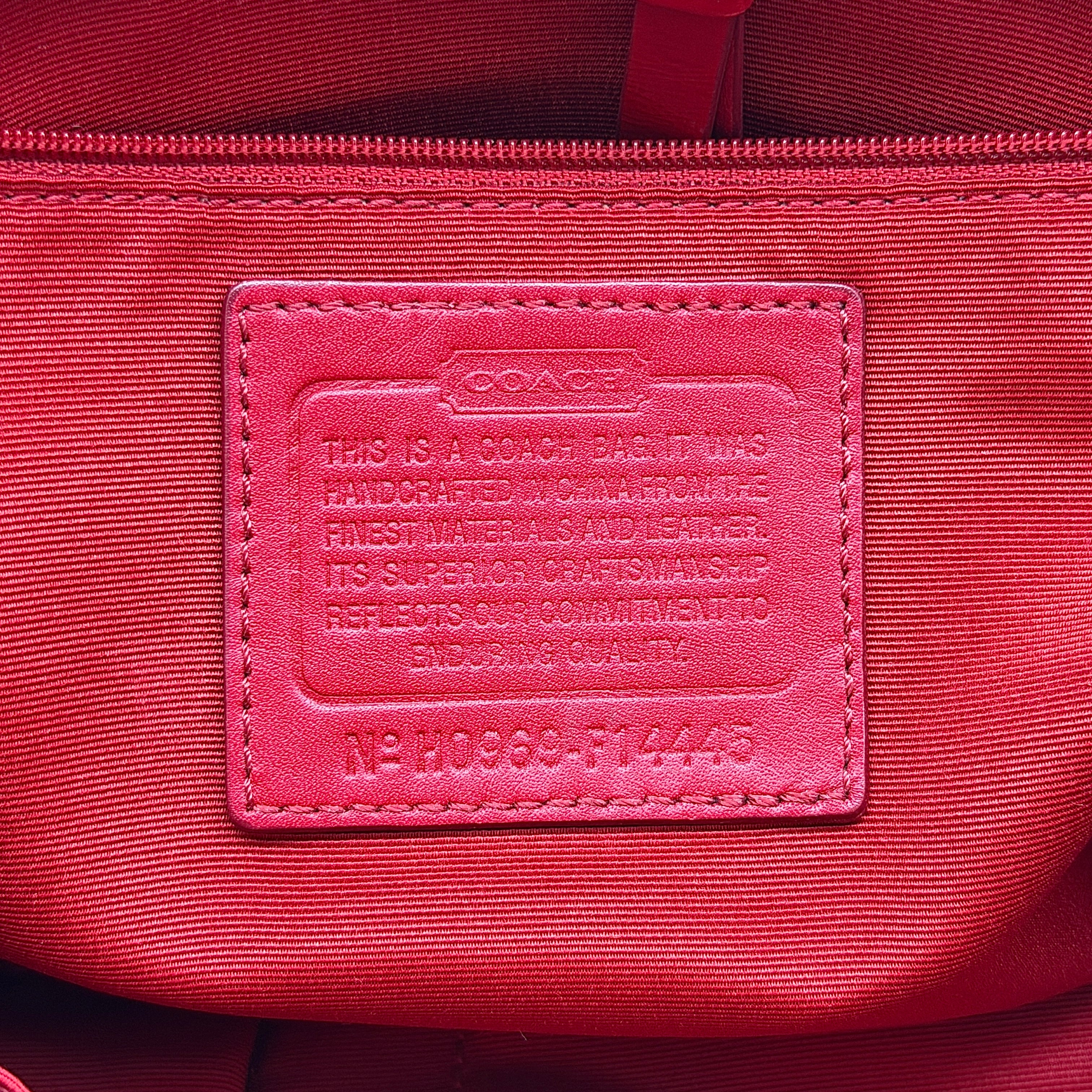 Coach Hampton Carryall in beige canvas with horse carriage motif, red leather trim, and double handles.