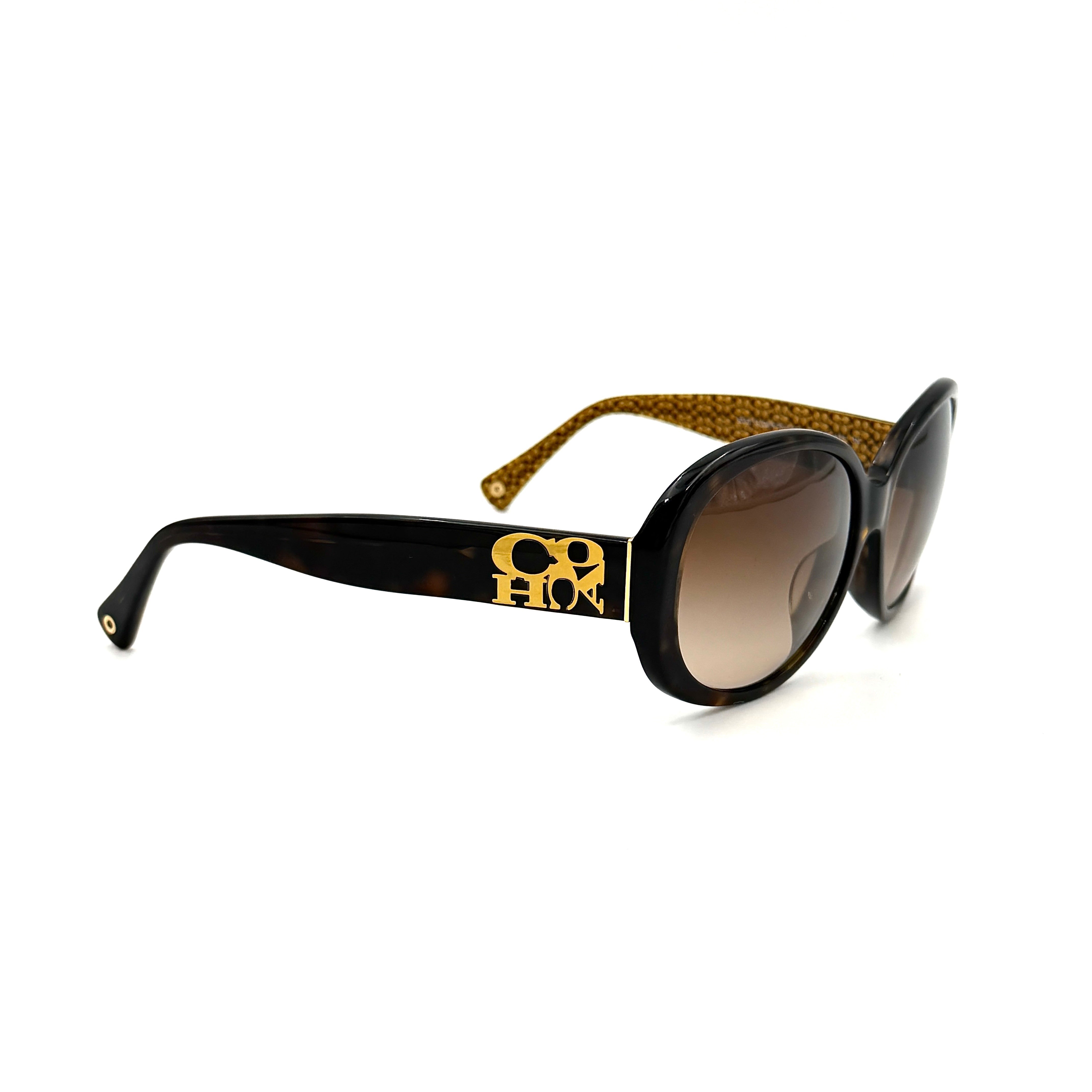 Coach HC8038F sunglasses in dark tortoise acetate with oversized oval frames and gold logo detail on the temple.