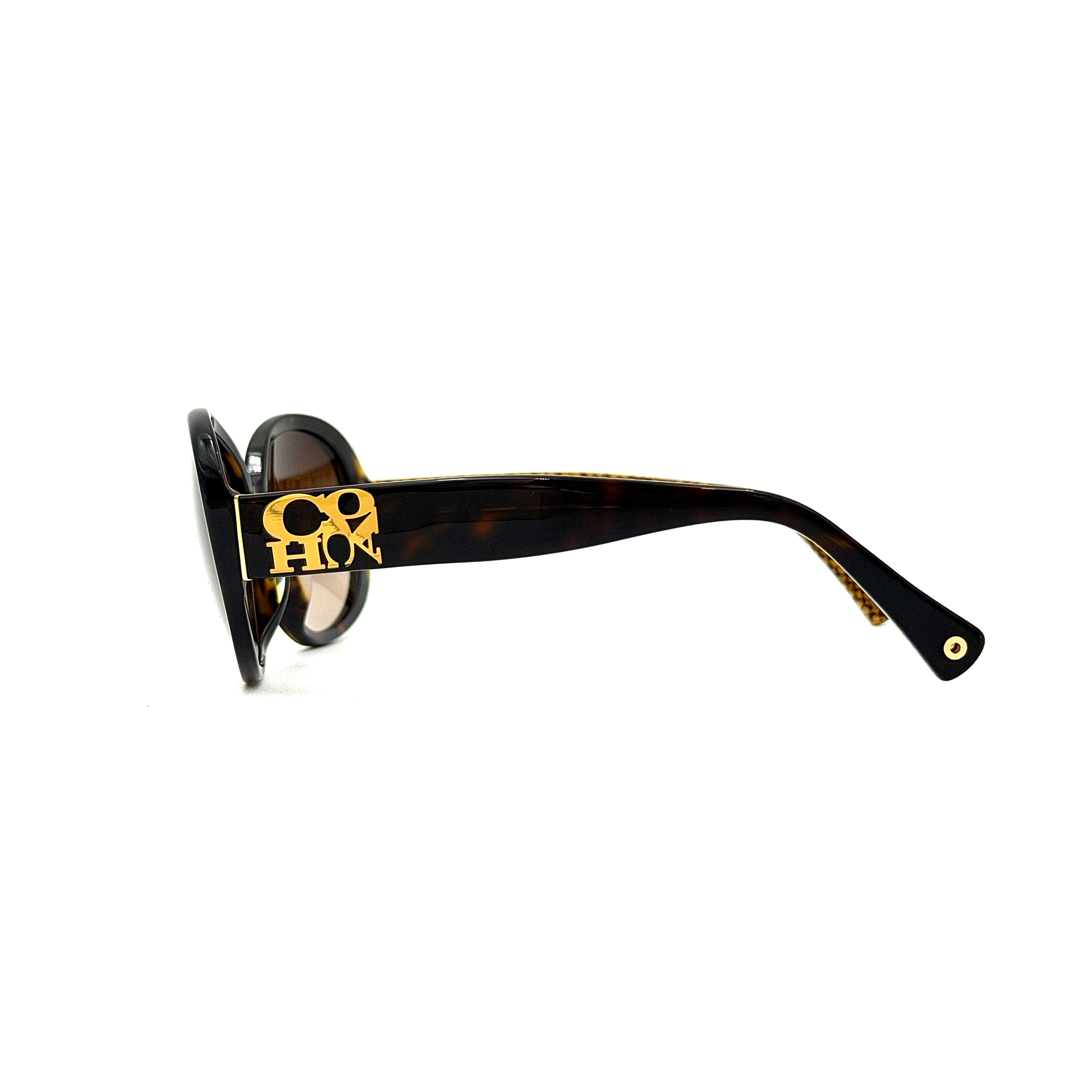 Coach HC8038F sunglasses in dark tortoise acetate with oversized oval frames and gold logo detail on the temple.