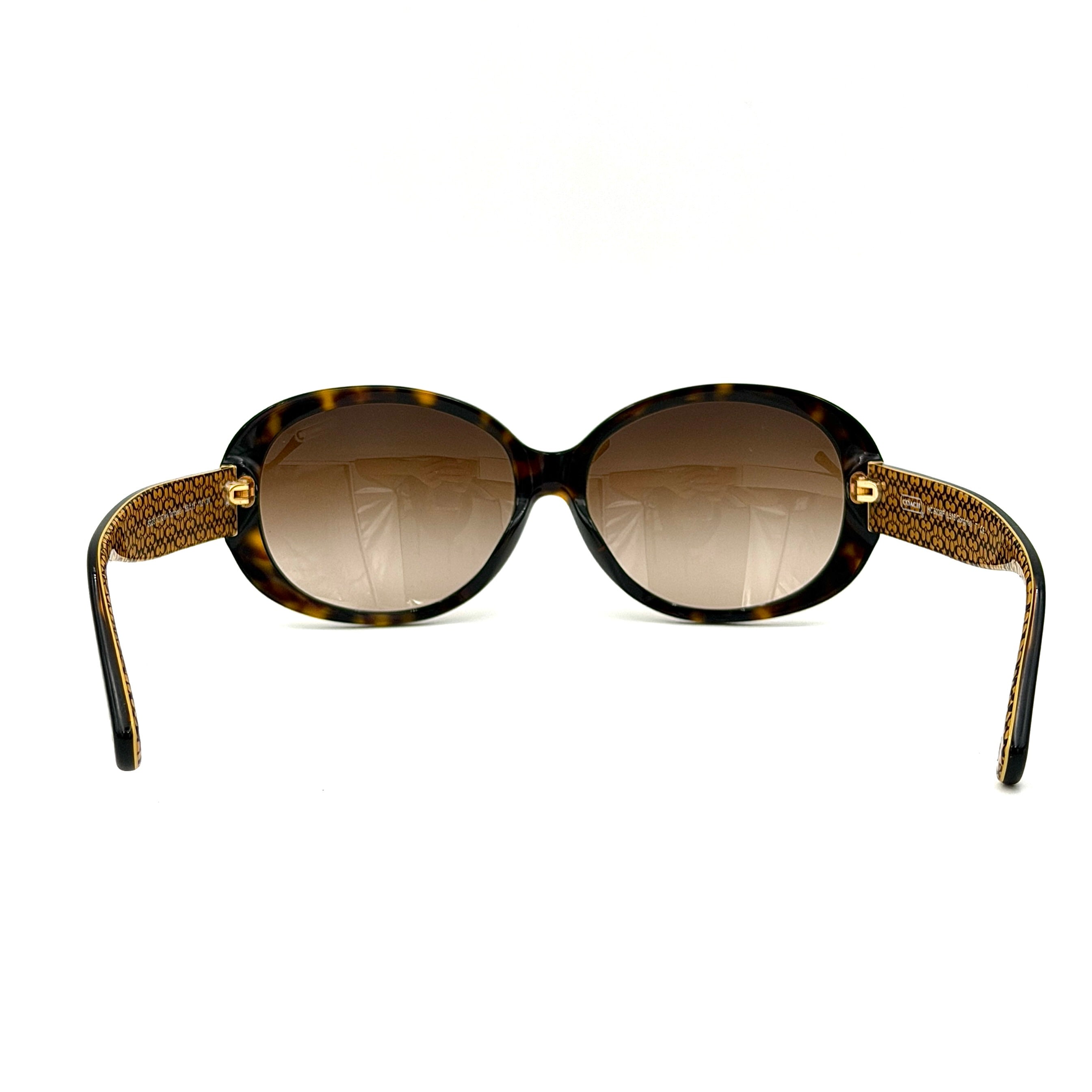 Coach HC8038F sunglasses in dark tortoise acetate with oversized oval frames and gold logo detail on the temple.