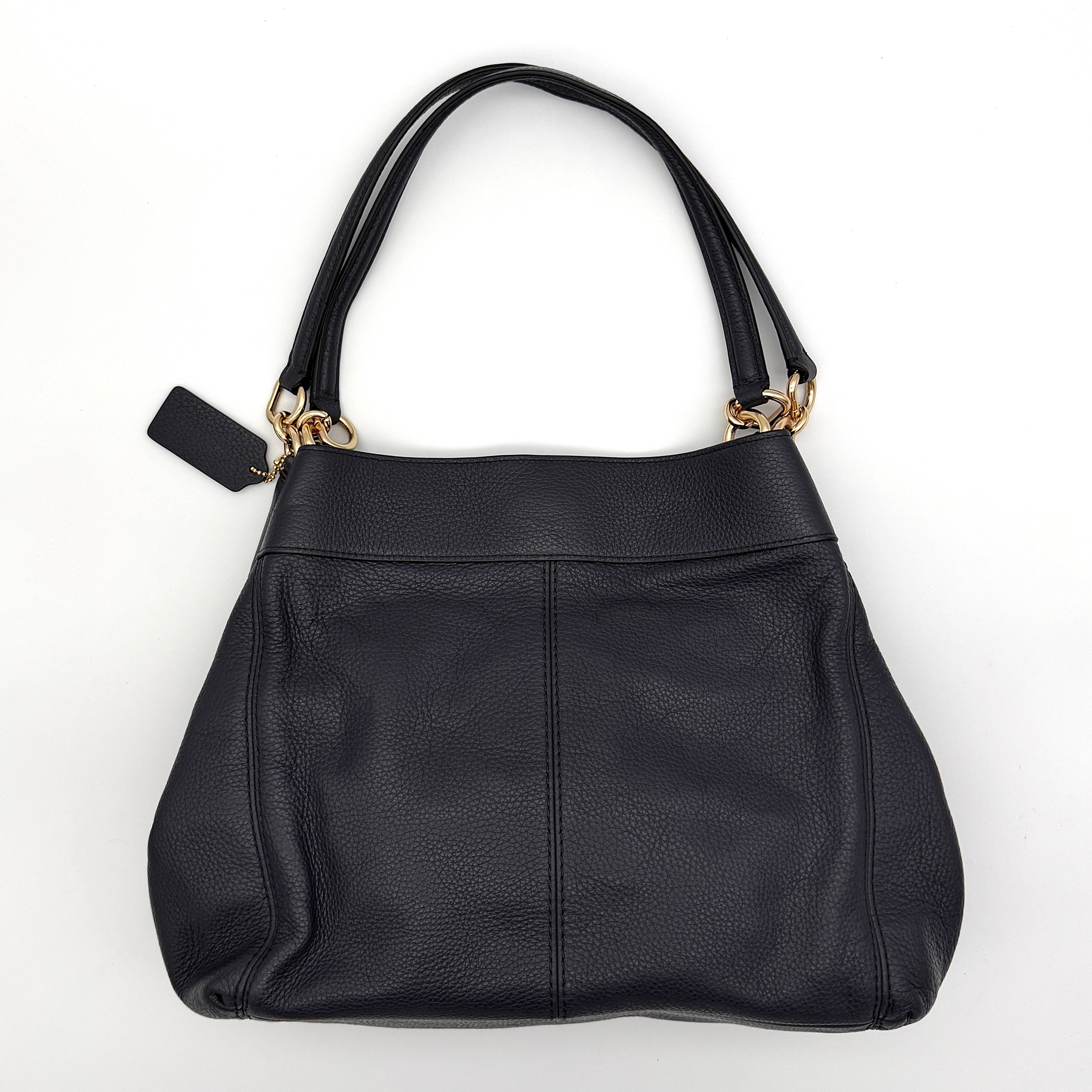 Coach Lexy shoulder bag in navy pebbled leather with gold-tone hardware and double handles.