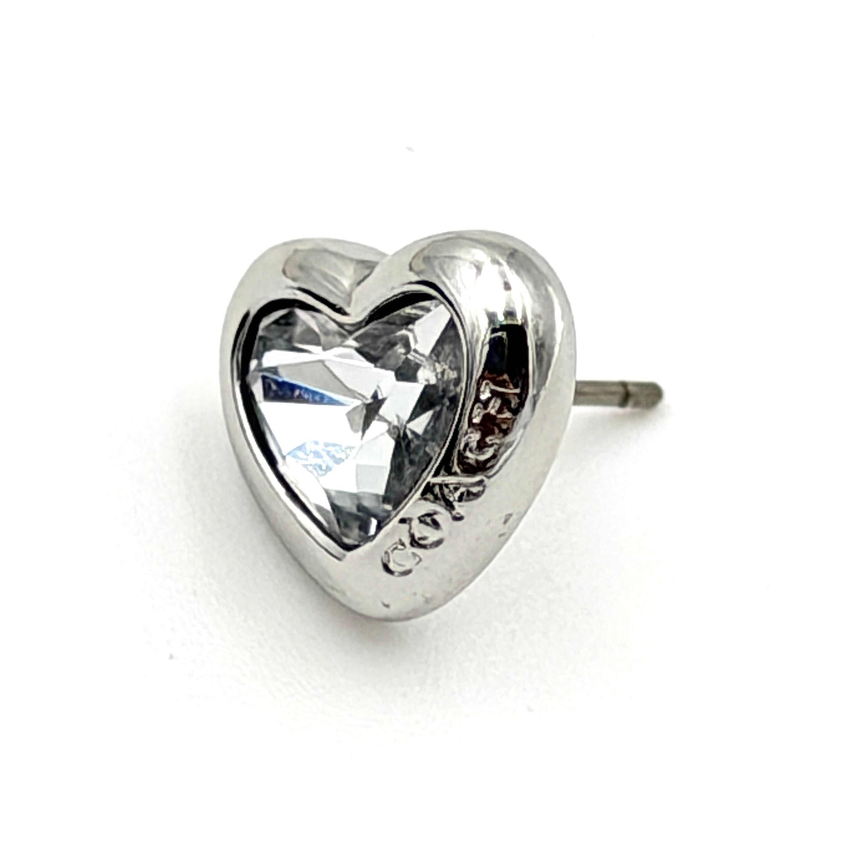A pair of Coach heart-shaped crystal stud earrings in silver-tone metal with engraved logo and faceted stones.