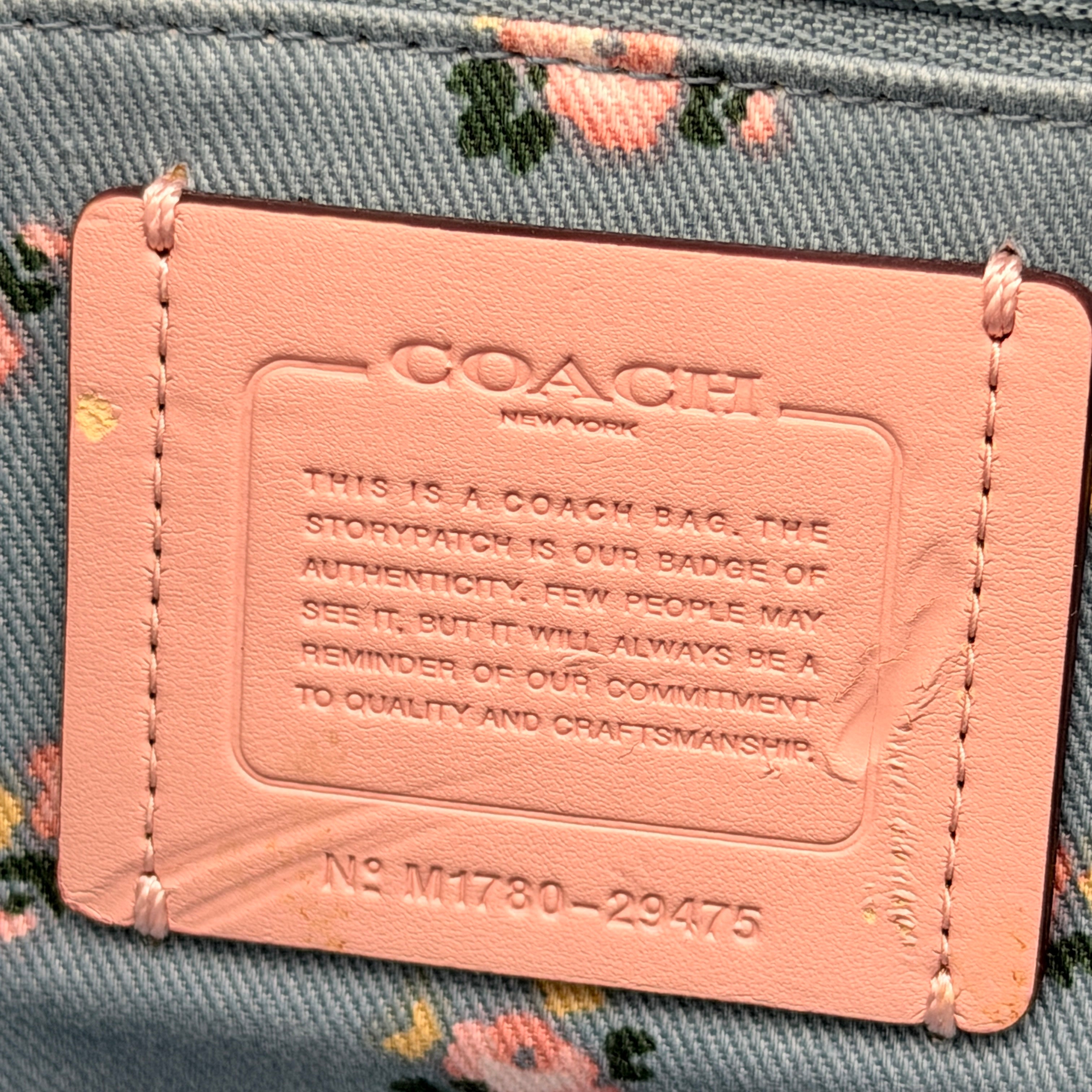 Coach Edie 2Way shoulder bag in navy denim with black leather trim, pink accents and gold hardware, shown with detachable strap.