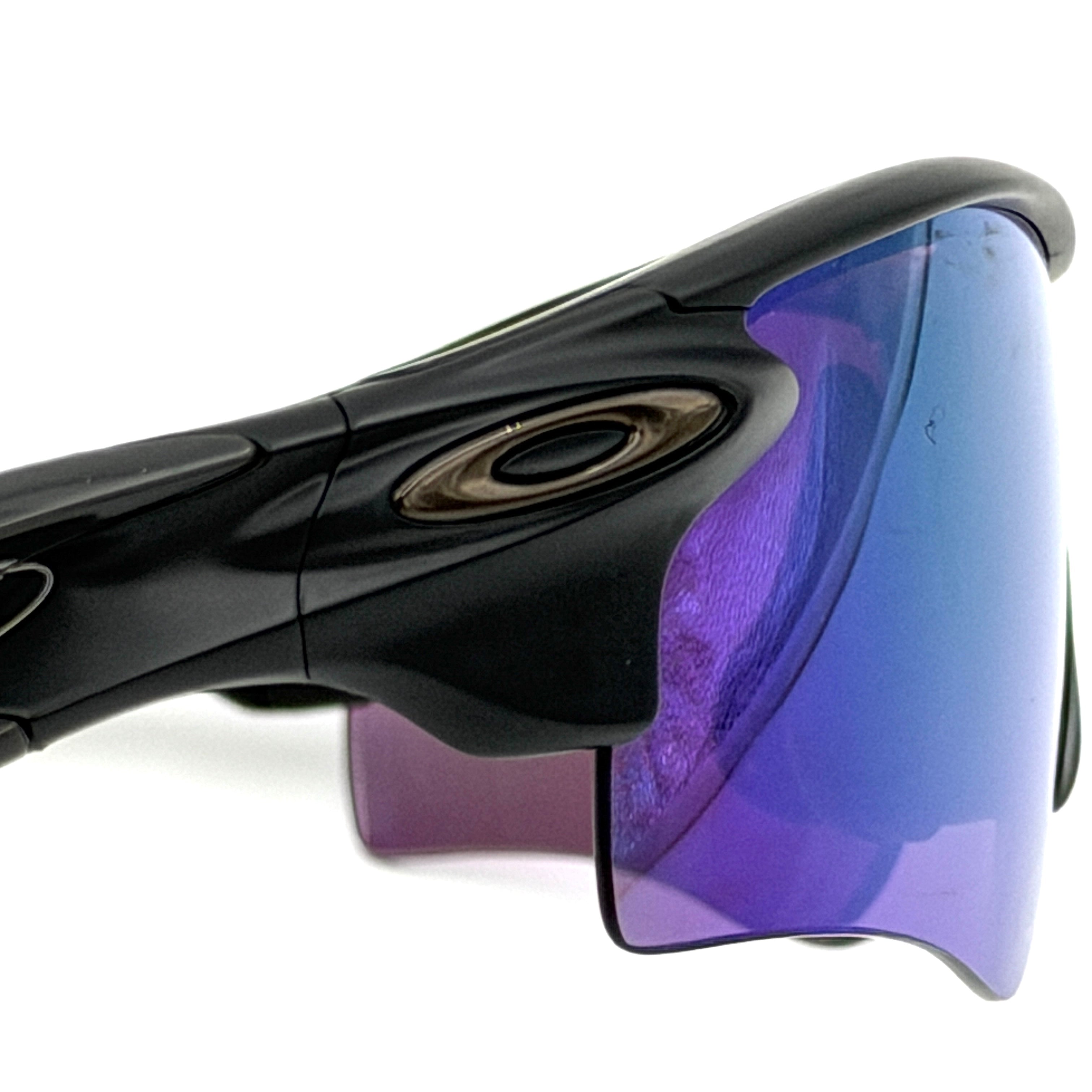 Oakley RadarLock Path sunglasses in matte black with reflective green and violet Prizm shield lens, presented with original black case, box, and cloth.