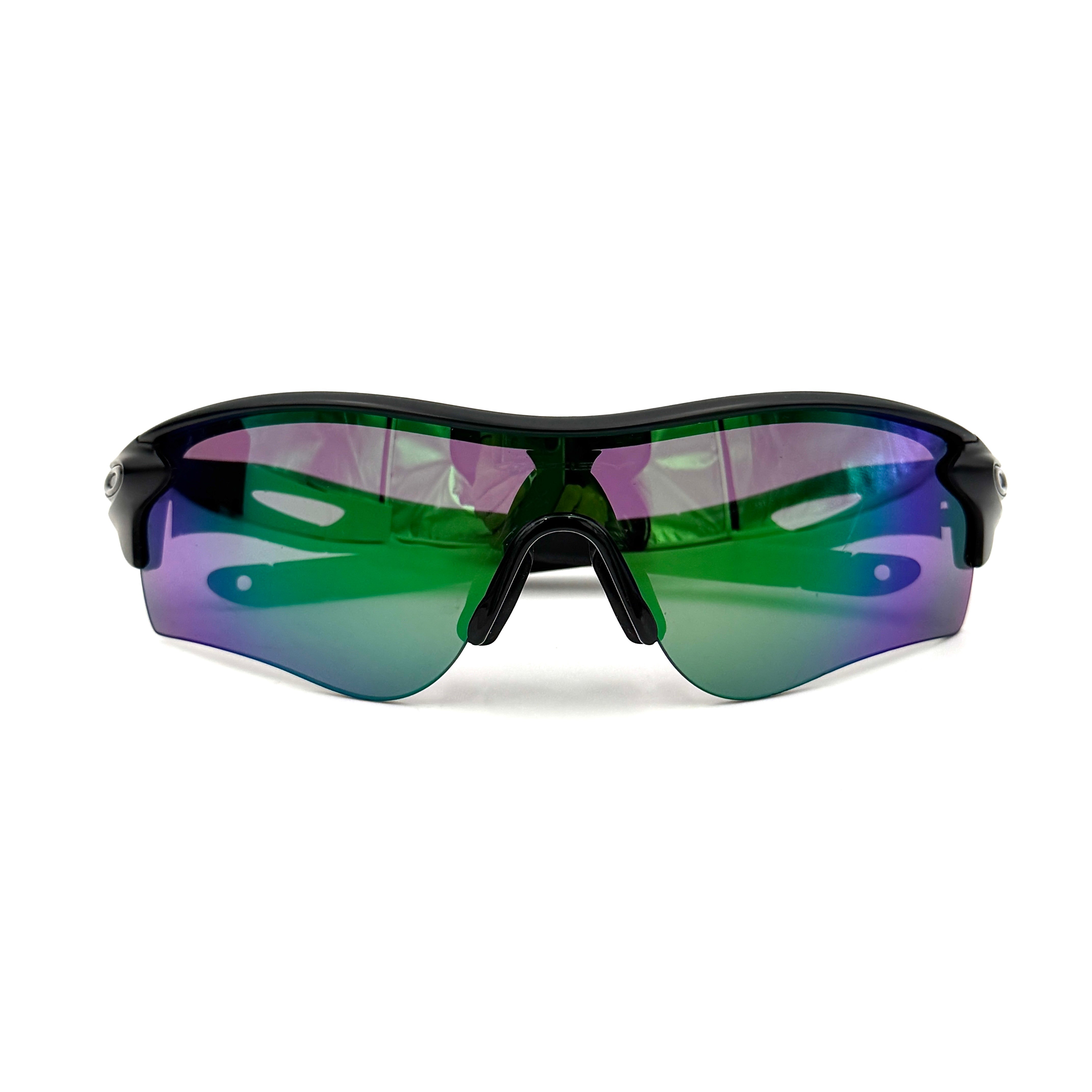 Oakley RadarLock Path sunglasses in matte black with reflective green and violet Prizm shield lens, presented with original black case, box, and cloth.