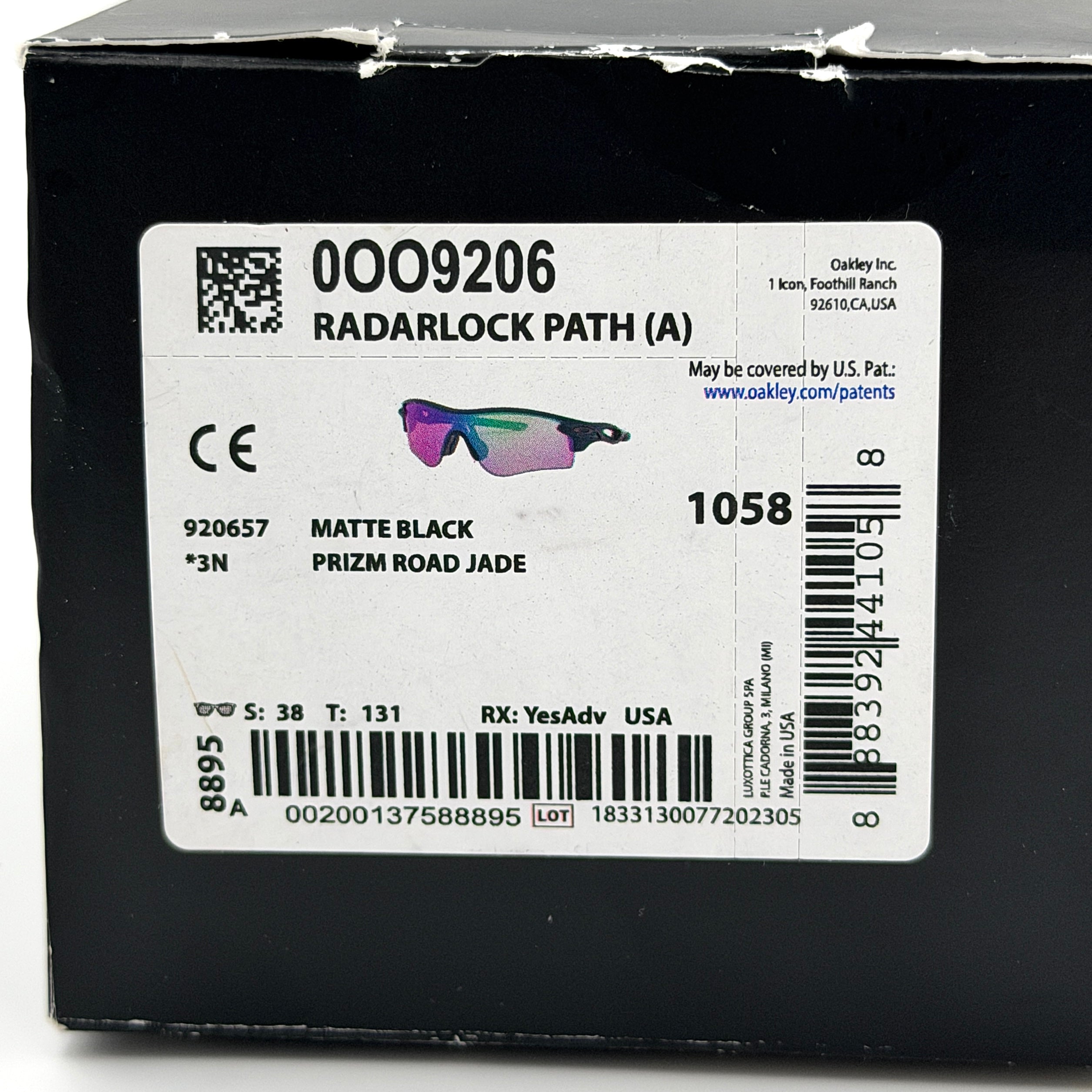 Oakley RadarLock Path sunglasses in matte black with reflective green and violet Prizm shield lens, presented with original black case, box, and cloth.