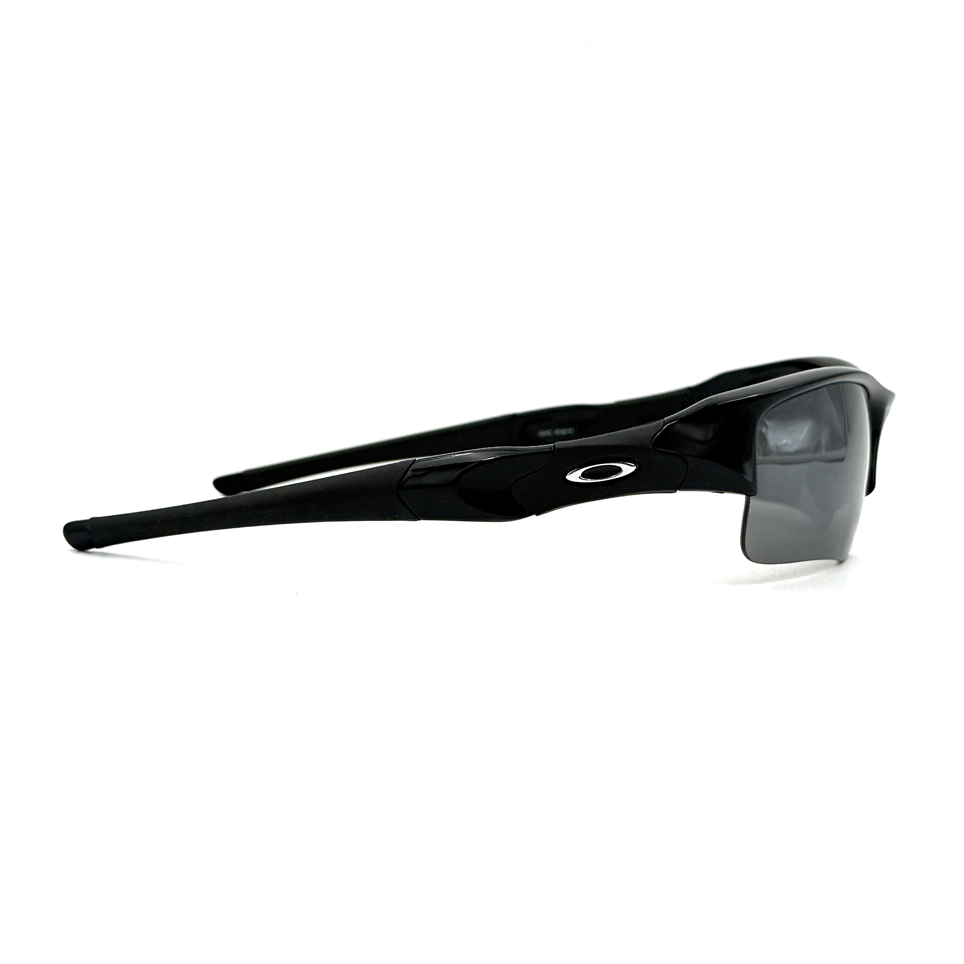 Oakley FLAK Jacket 03-915 sunglasses in black with grey lenses, shown with original zip case.