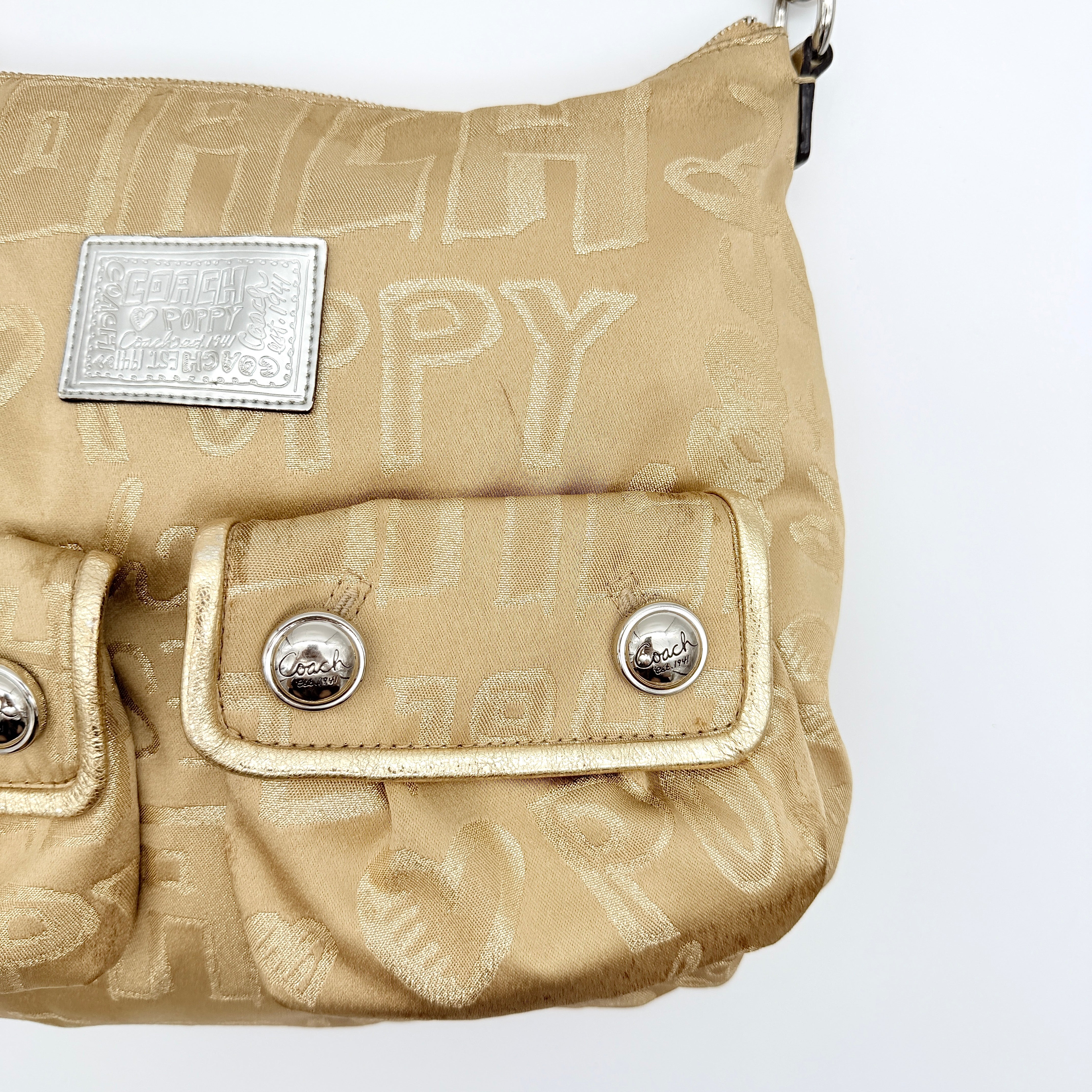 Coach Signature Poppy Pocket Hobo in beige sateen with metallic gold trim and silver hardware, shown with detachable strap.