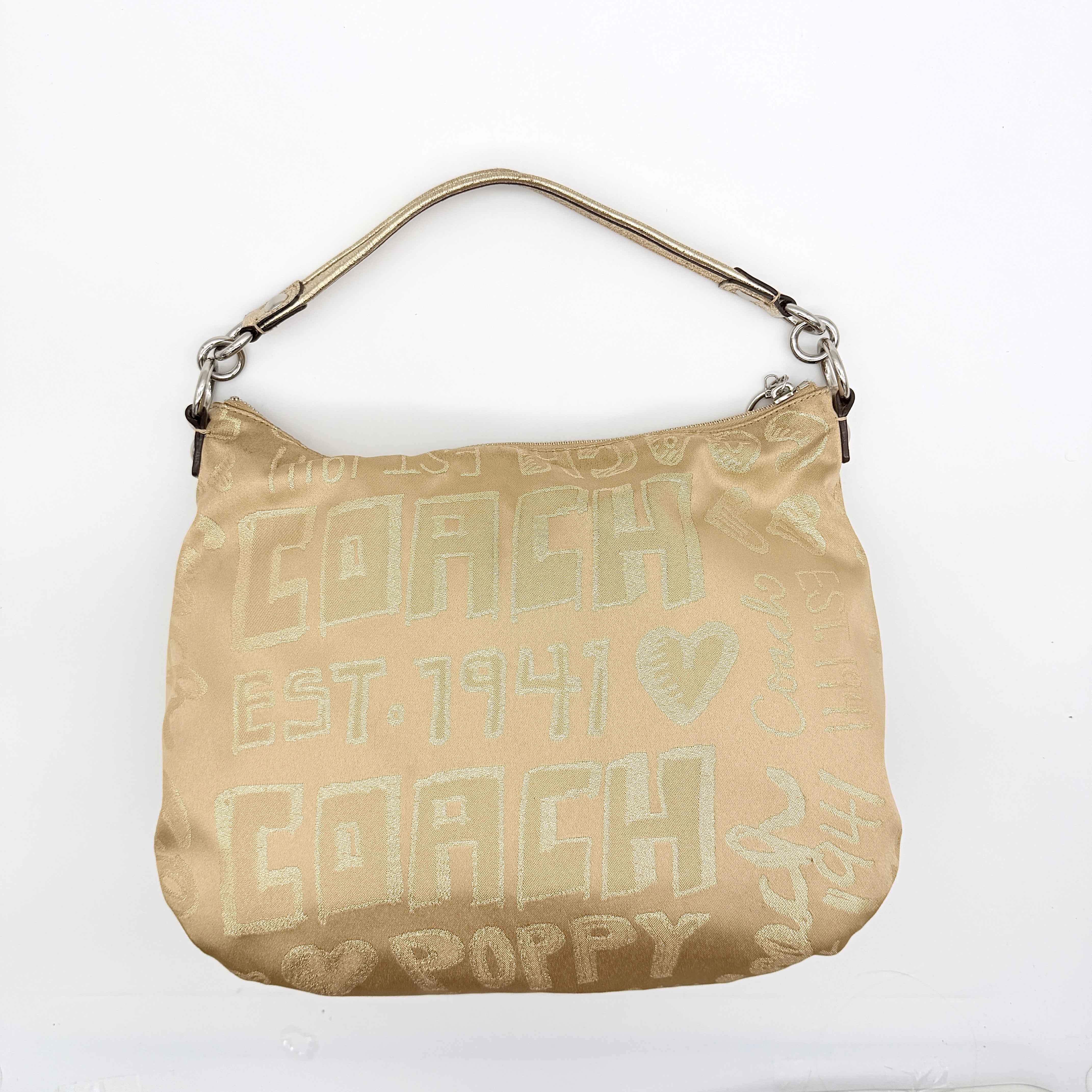 Coach Signature Poppy Pocket Hobo in beige sateen with metallic gold trim and silver hardware, shown with detachable strap.