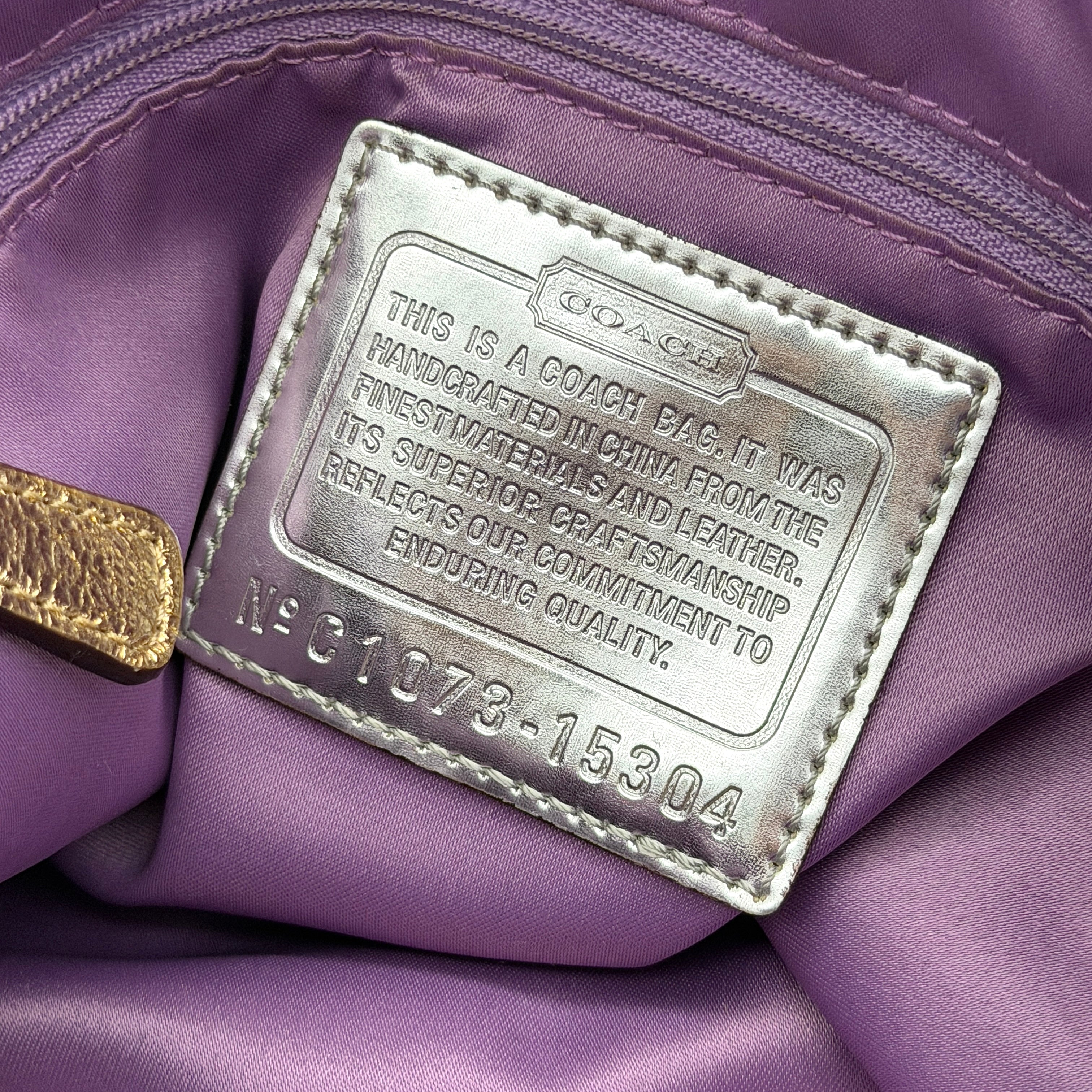 Coach Signature Poppy Pocket Hobo in beige sateen with metallic gold trim and silver hardware, shown with detachable strap.