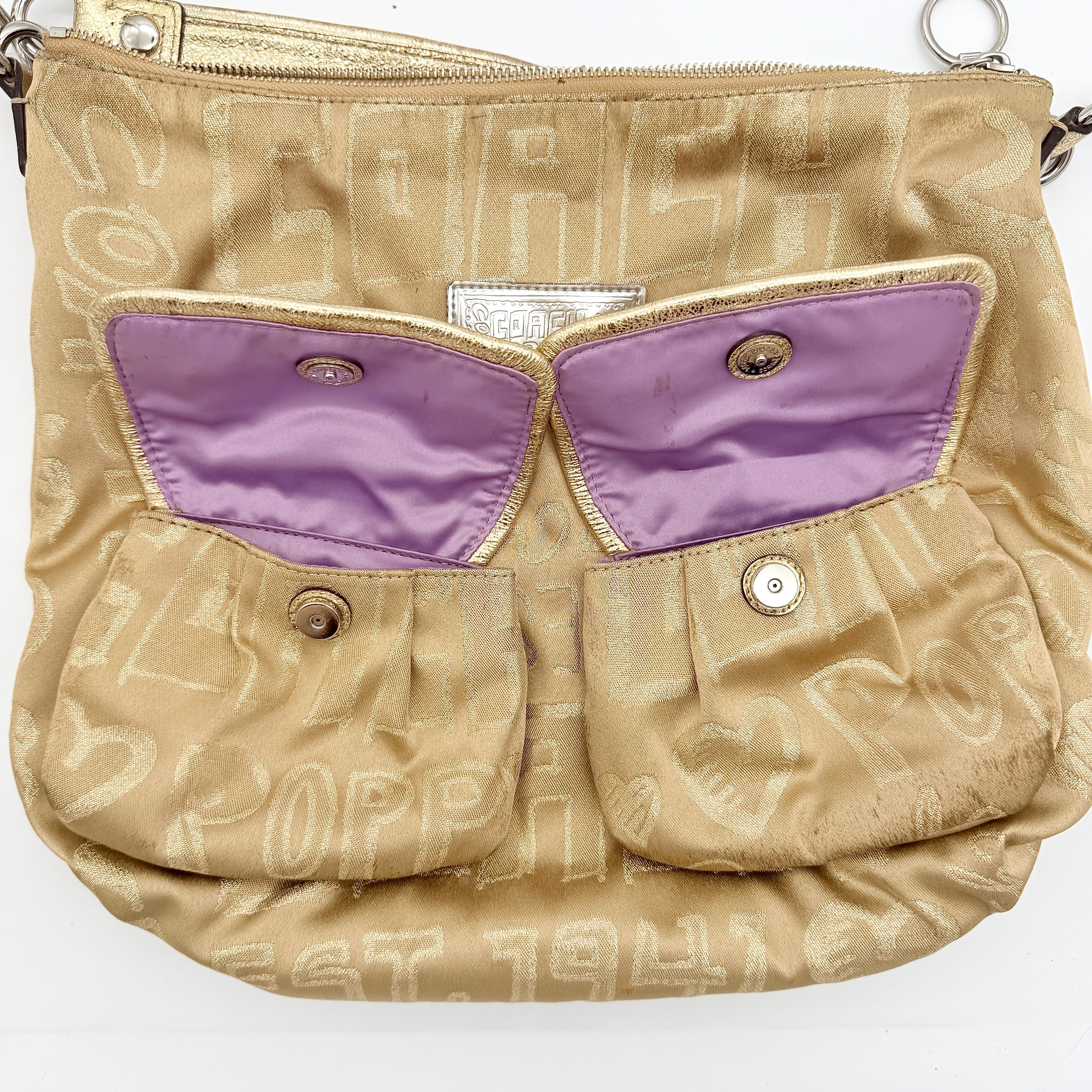 Coach Signature Poppy Pocket Hobo in beige sateen with metallic gold trim and silver hardware, shown with detachable strap.