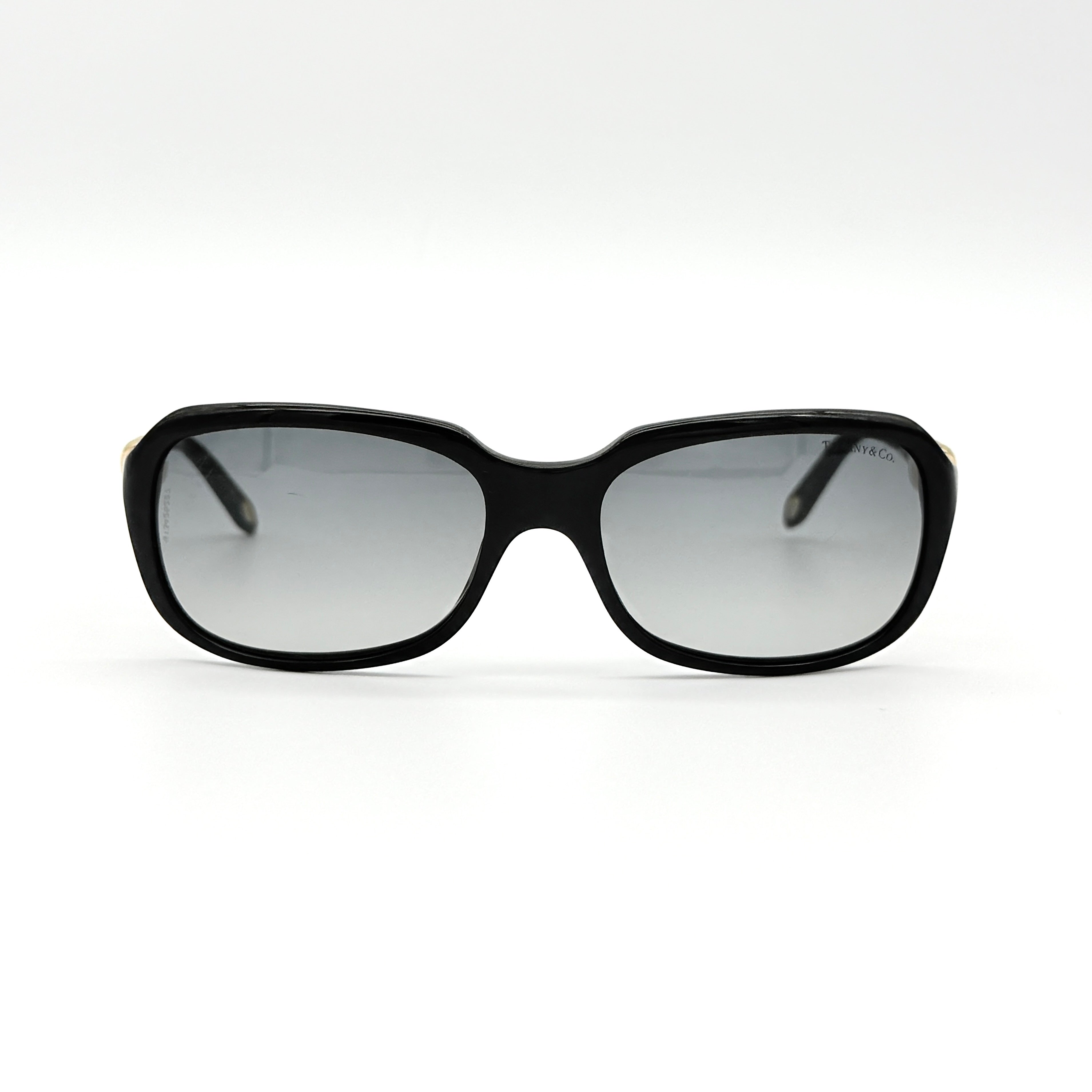 Tiffany & Co. TF4023 sunglasses in black with gold hardware, displayed with original turquoise case and accessories.