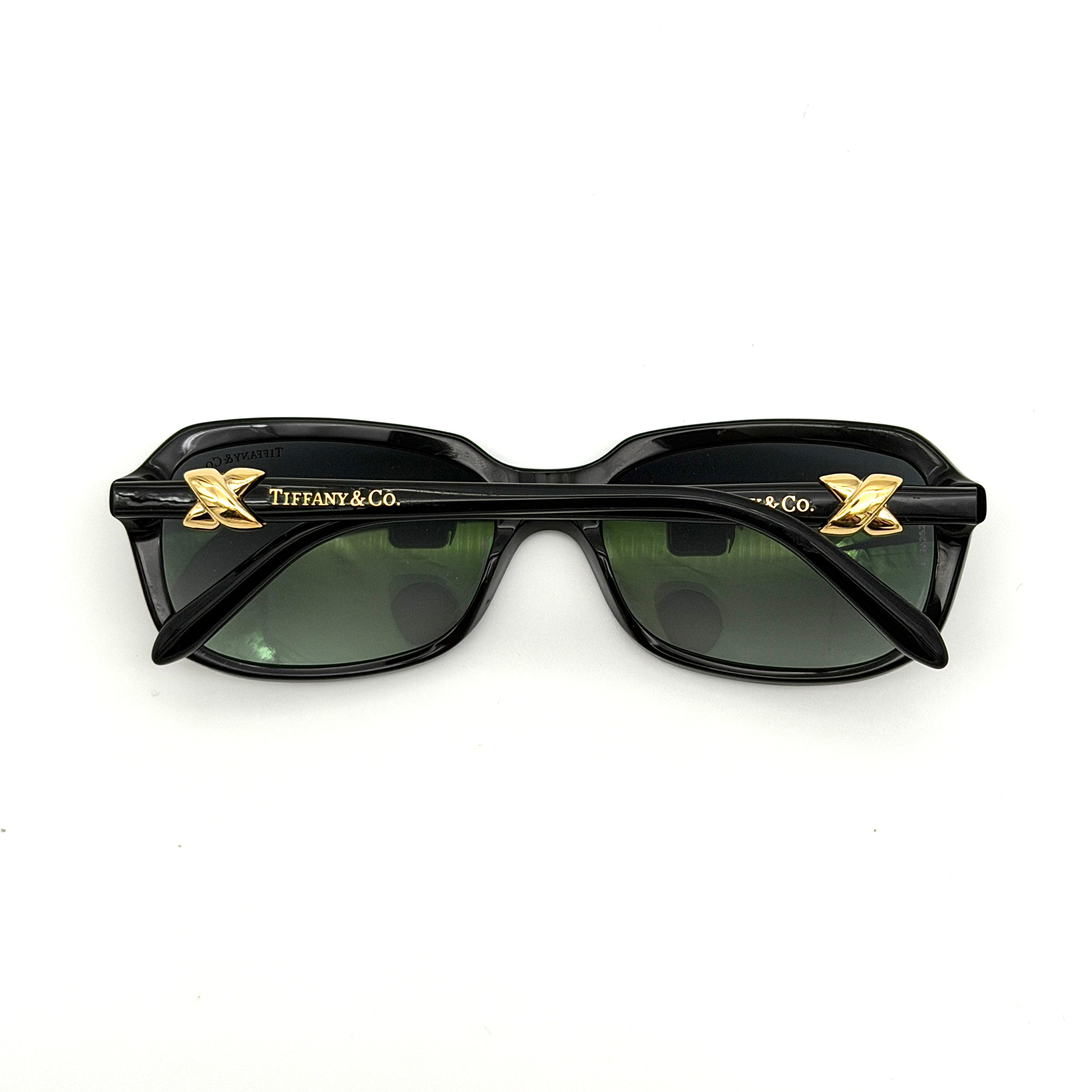 Tiffany & Co. TF4023 sunglasses in black with gold hardware, displayed with original turquoise case and accessories.