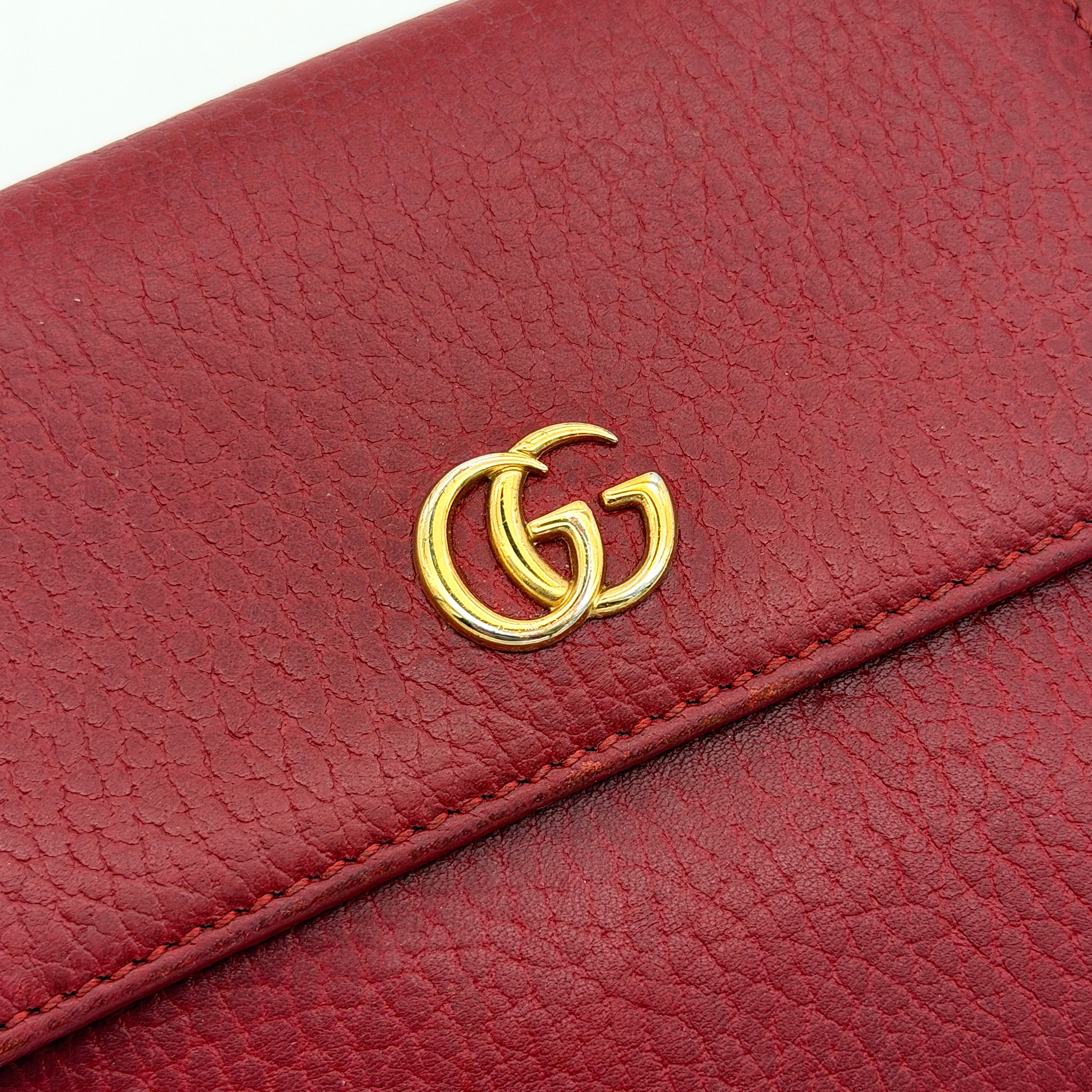 Gucci GG Marmont wallet in red grained leather with gold GG logo, presented with original box and dust bag.