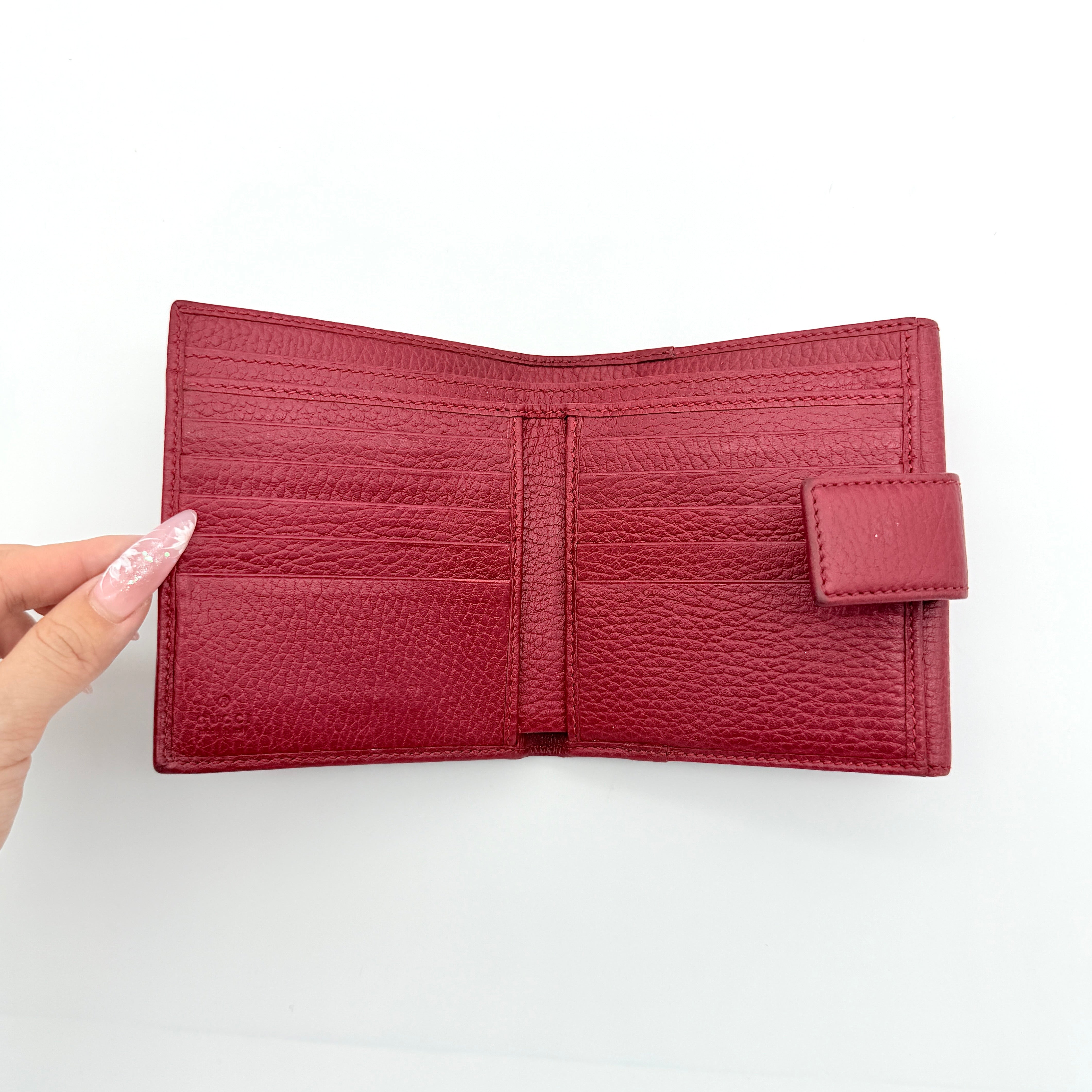 Gucci GG Marmont wallet in red grained leather with gold GG logo, presented with original box and dust bag.