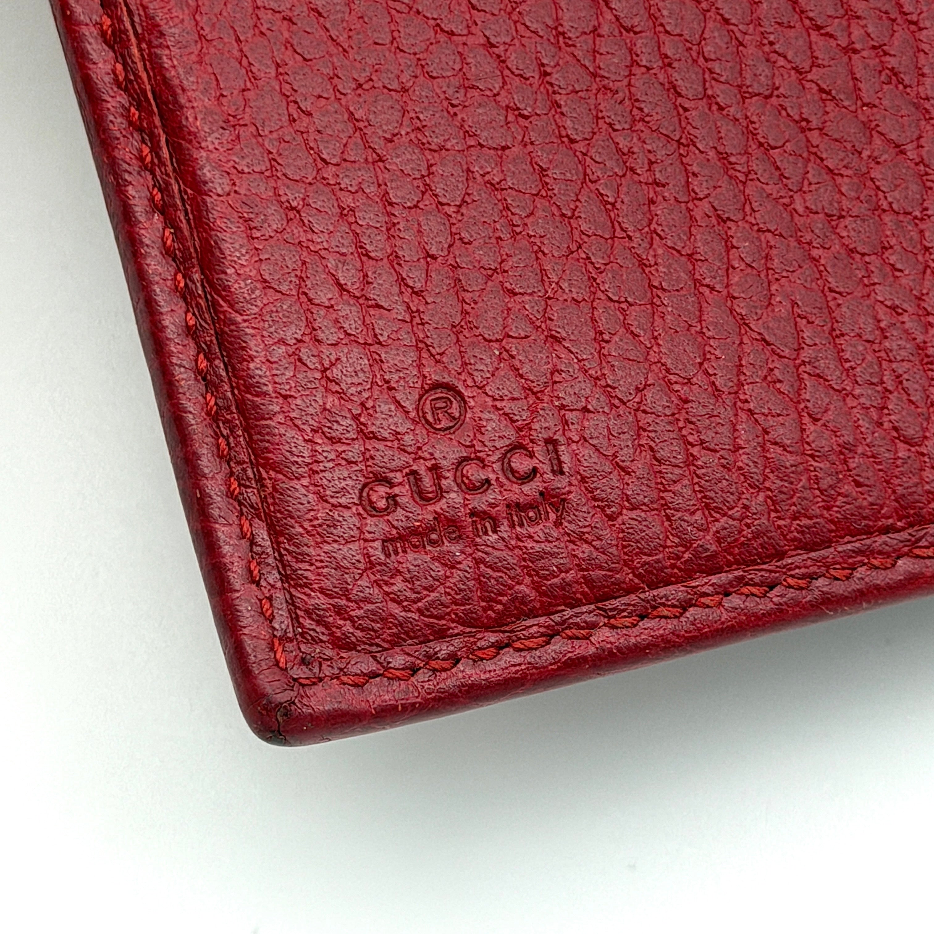 Gucci GG Marmont wallet in red grained leather with gold GG logo, presented with original box and dust bag.