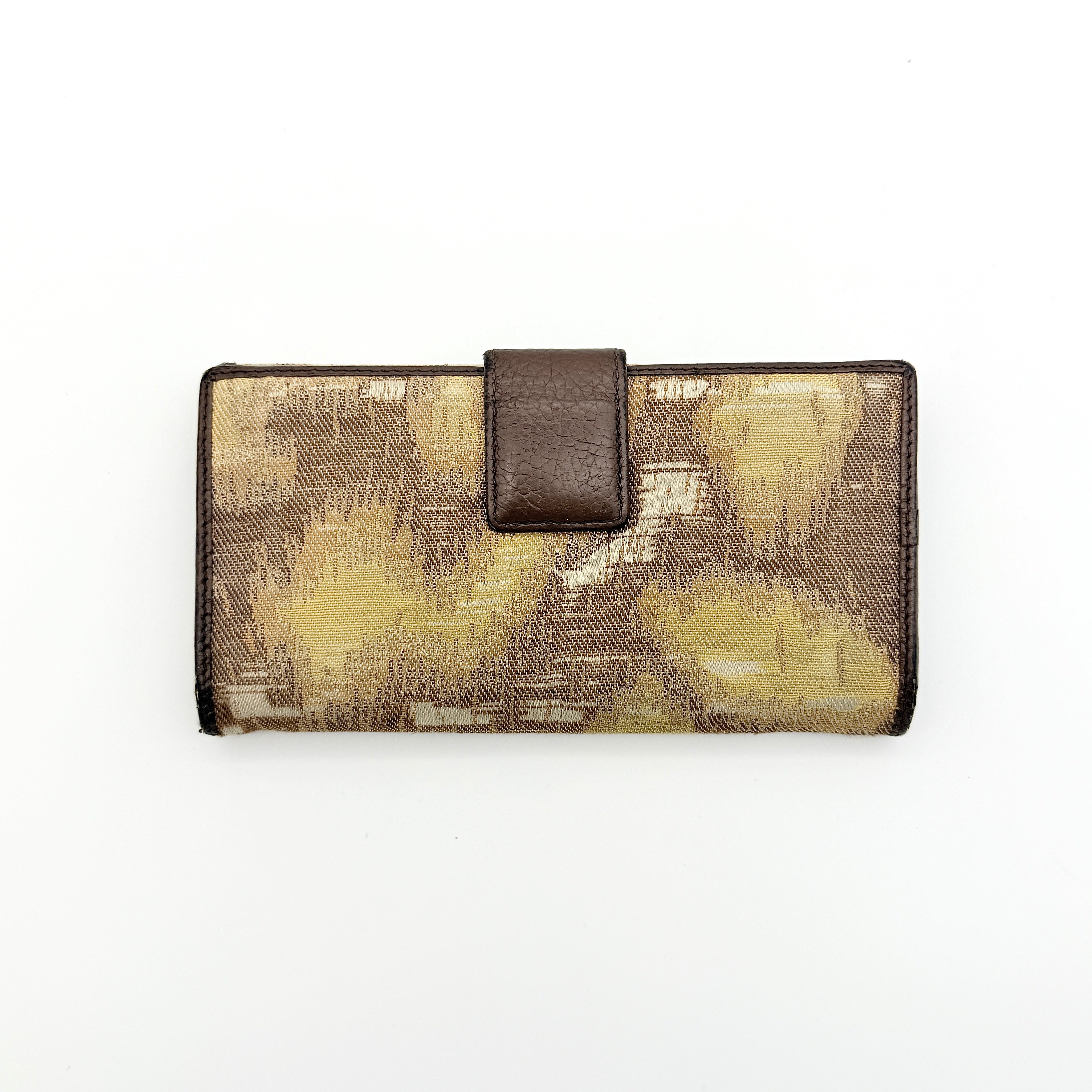 Vivienne Westwood Orb long wallet in beige and brown canvas with the signature Orb logo and leather trim, photographed on a white background.