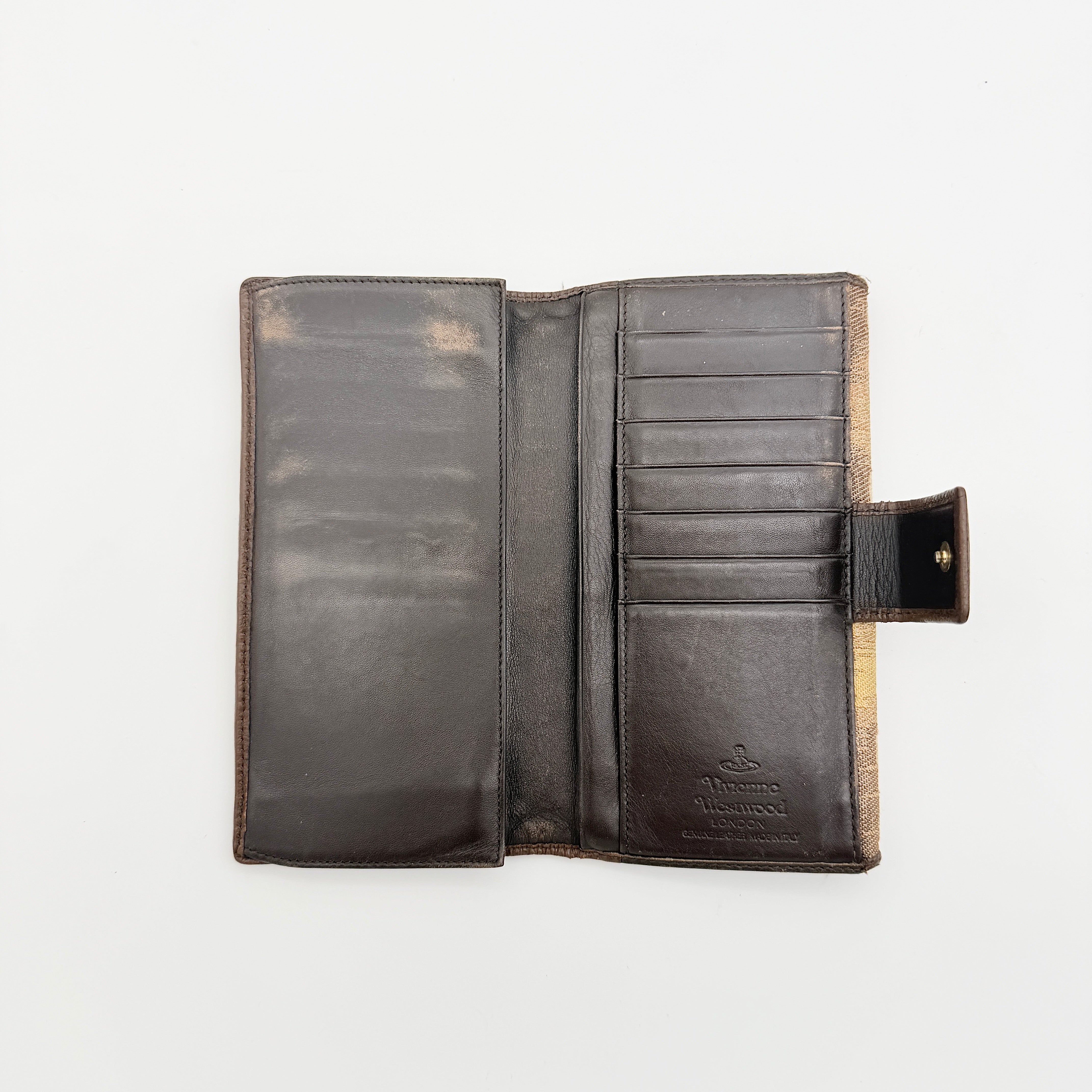 Vivienne Westwood Orb long wallet in beige and brown canvas with the signature Orb logo and leather trim, photographed on a white background.