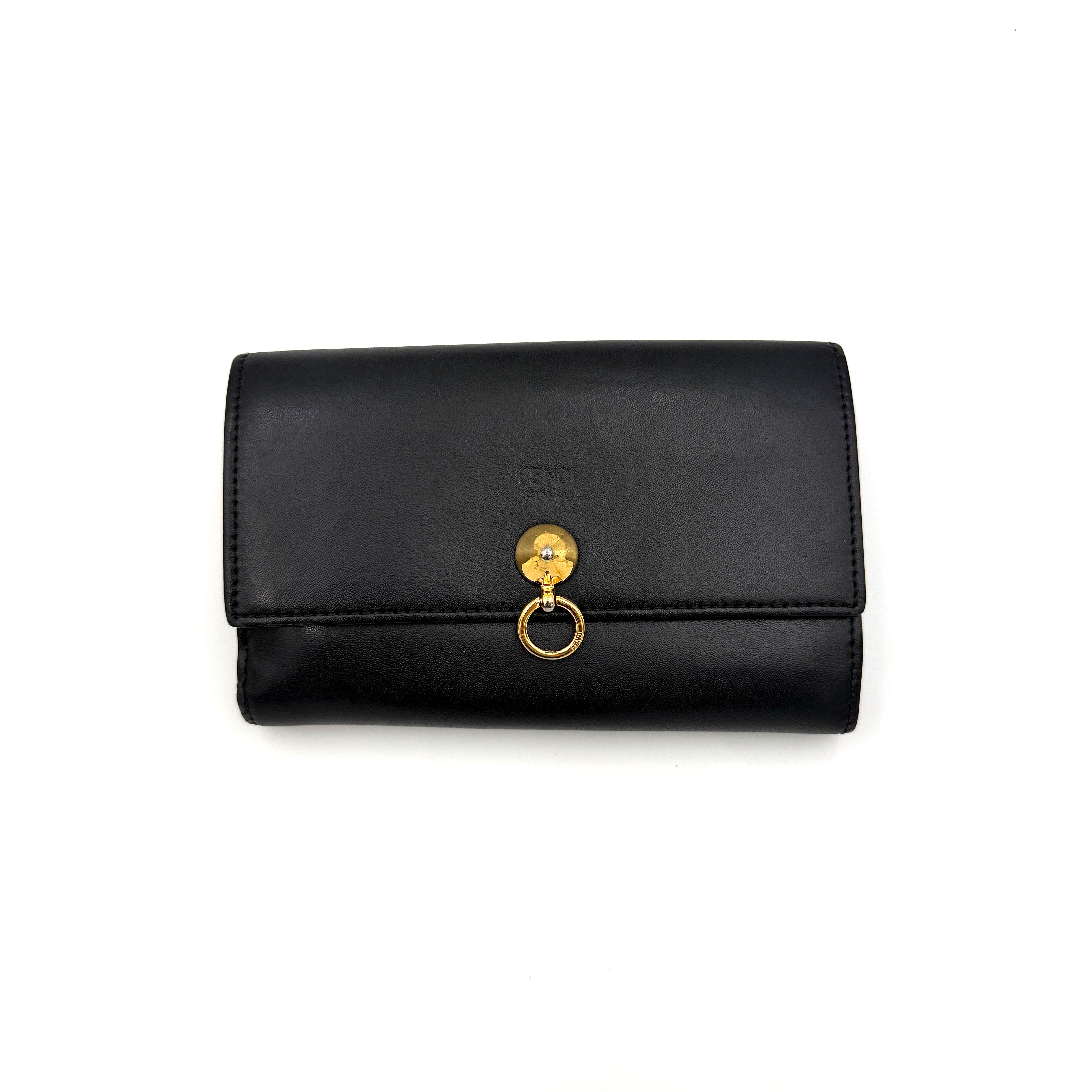 Fendi By The Way Leather Long Wallet in black with gold-tone disc and ring detail on the front flap.