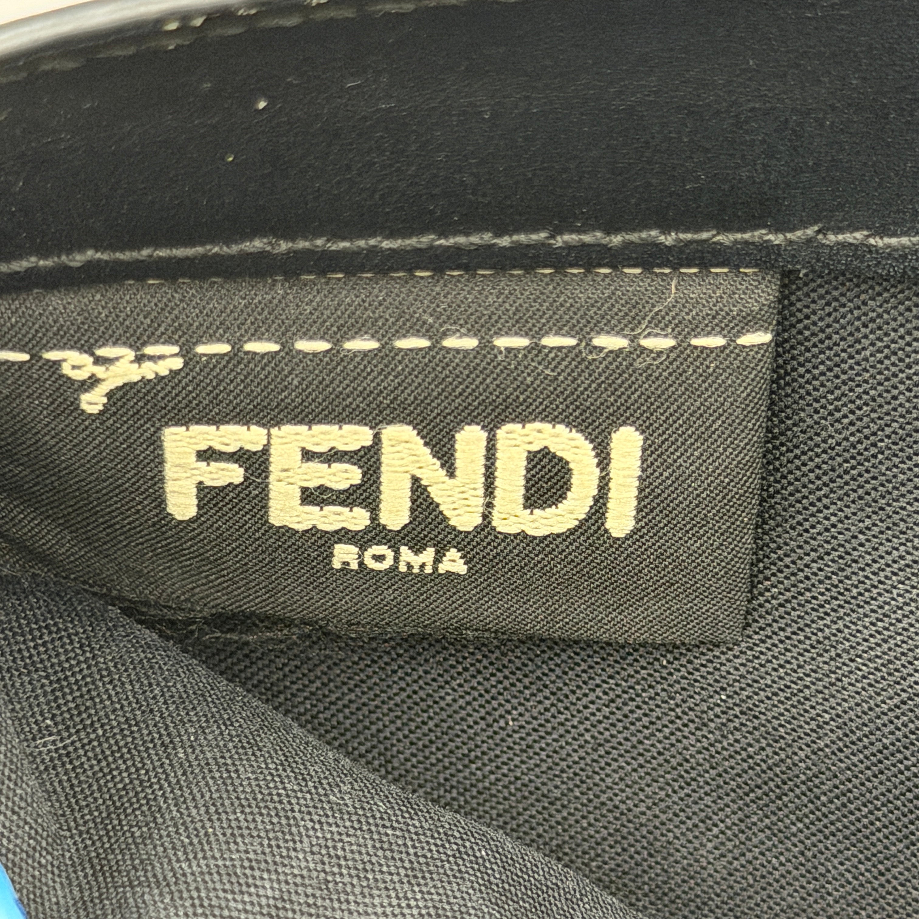Fendi By The Way Leather Long Wallet in black with gold-tone disc and ring detail on the front flap.