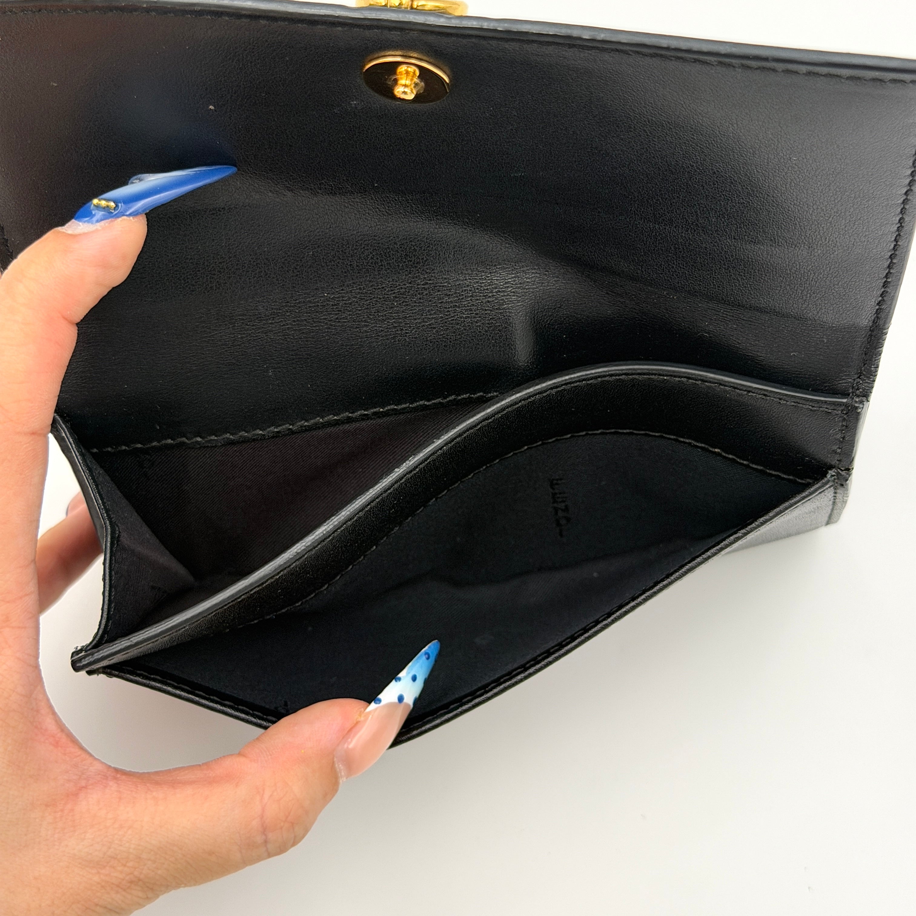Fendi By The Way Leather Long Wallet in black with gold-tone disc and ring detail on the front flap.