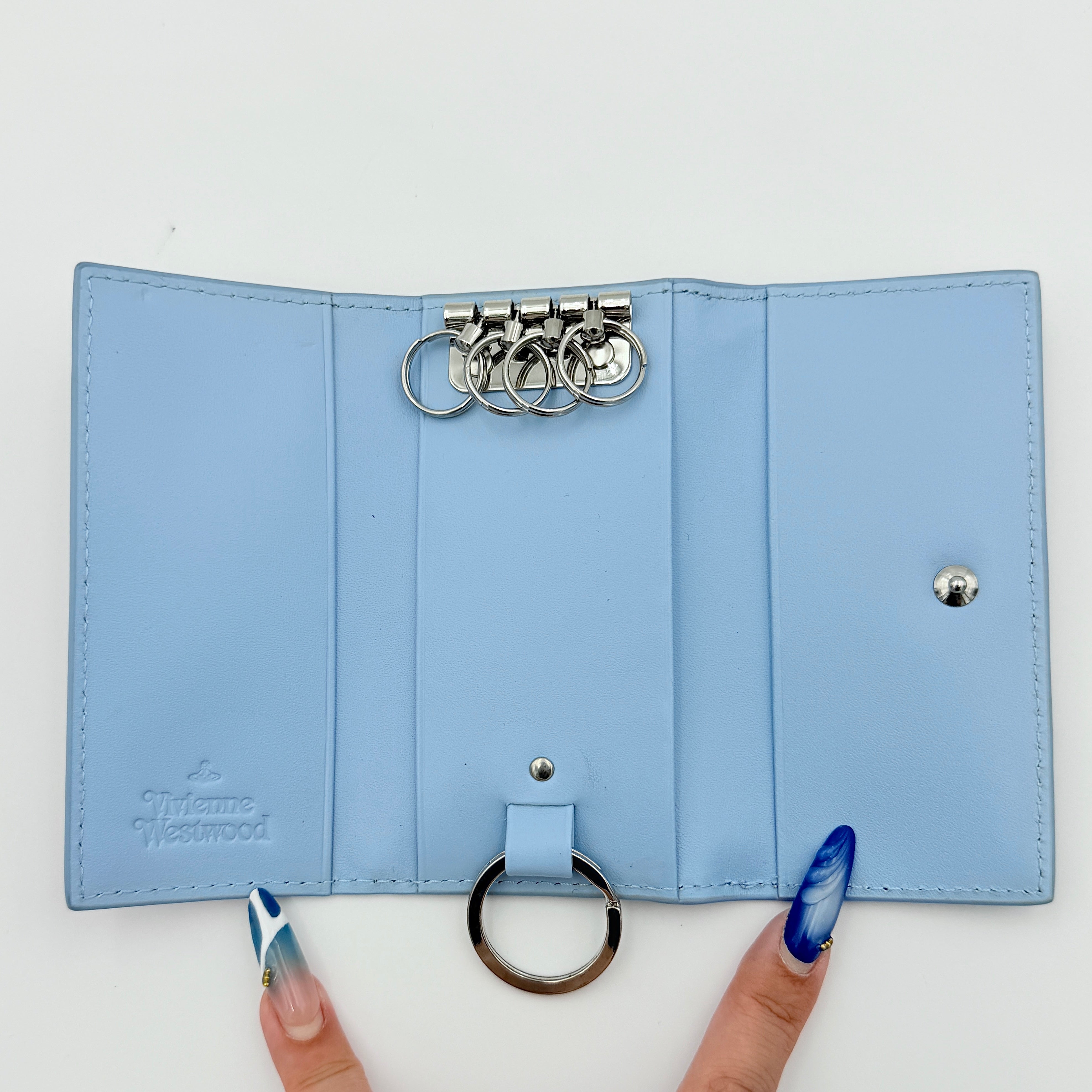 Vivienne Westwood Messy Bugs Key Holder in baby blue leather with a colourful insect motif and silver orb hardware.