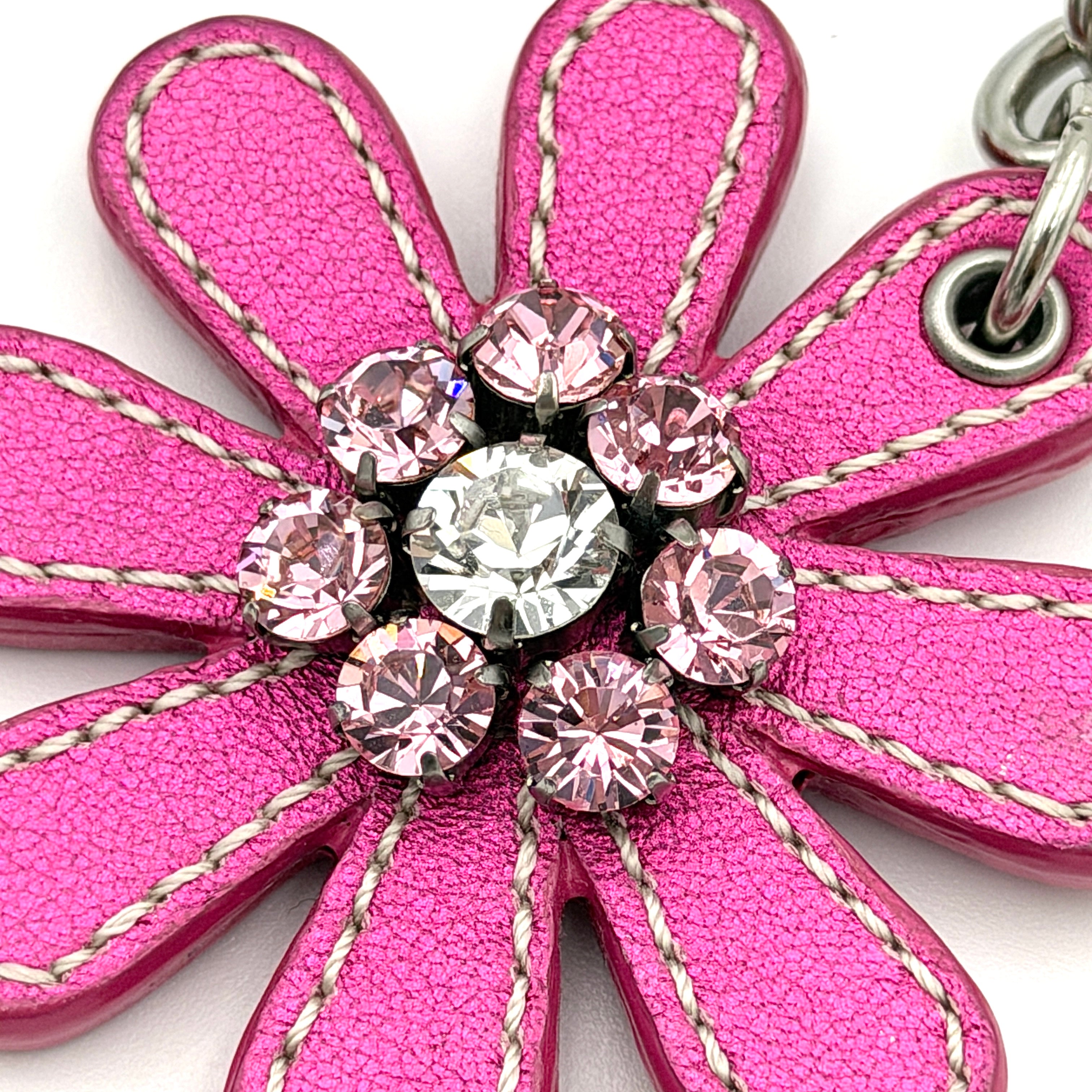 Coach Daisy Flow Bag Charm in magenta leather, featuring crystal accents and silver-tone hardware, styled with precise stitching.