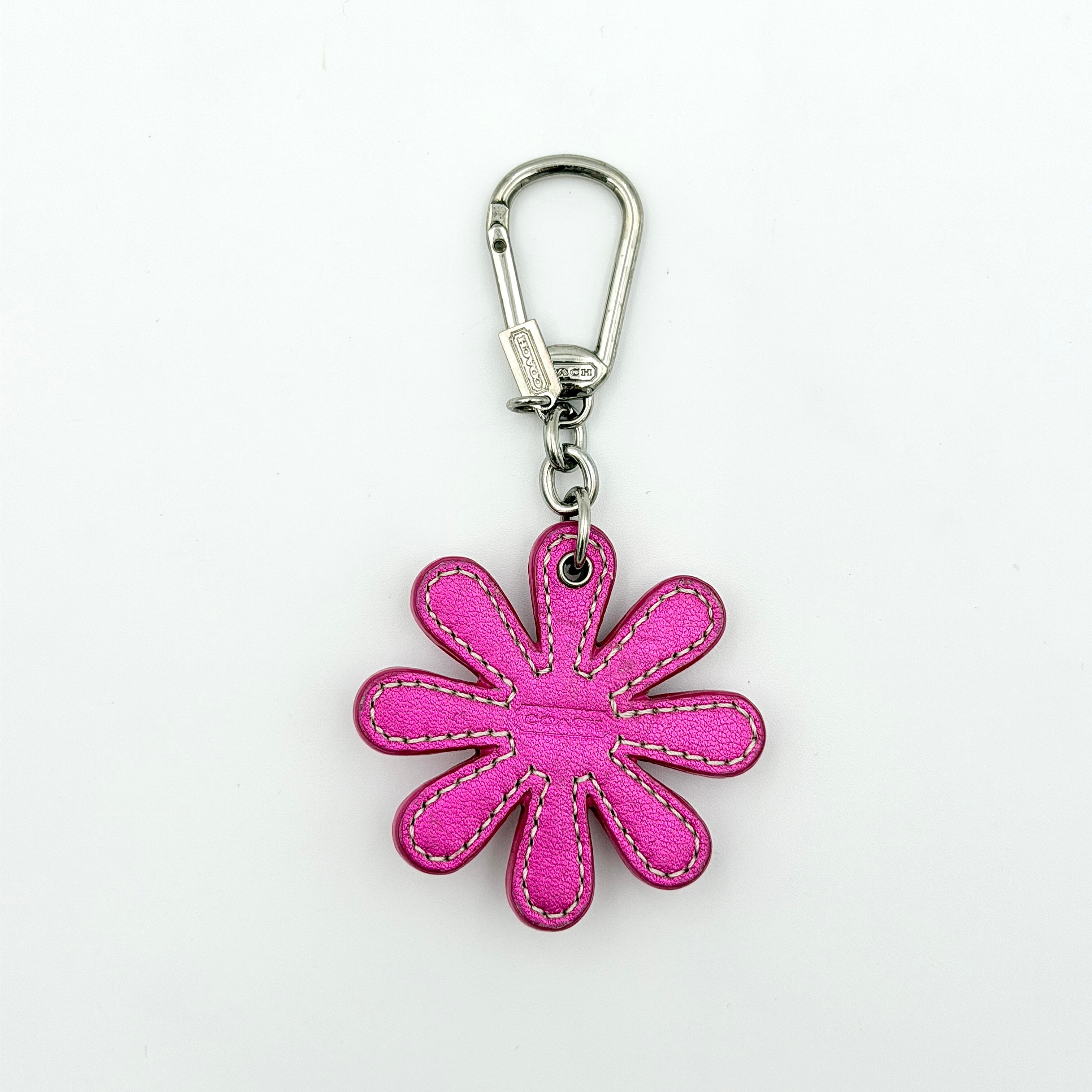 Coach Daisy Flow Bag Charm in magenta leather, featuring crystal accents and silver-tone hardware, styled with precise stitching.