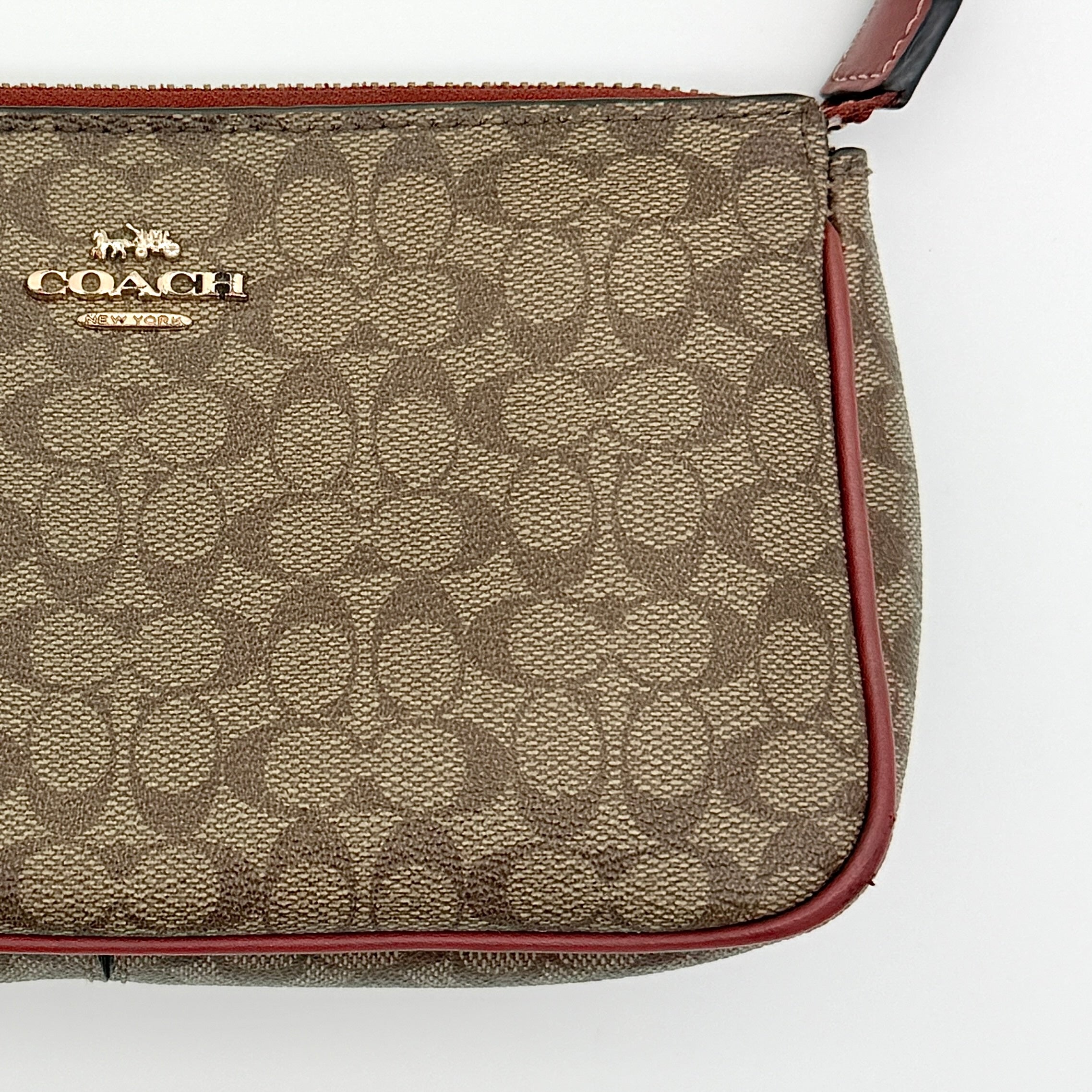 Coach Nolita 19 shoulder bag in beige monogram canvas with red leather trim and gold hardware, top view with strap.