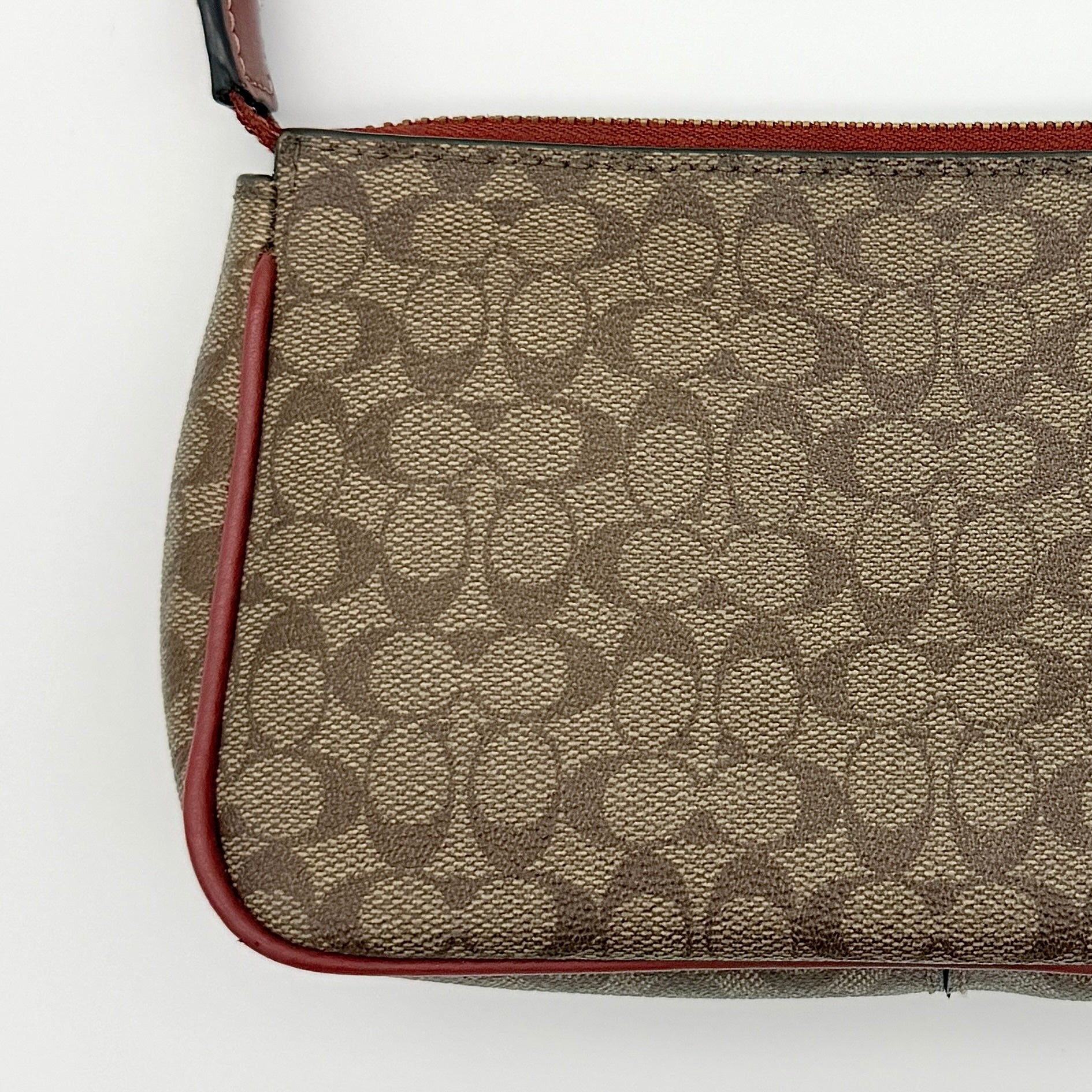 Coach Nolita 19 shoulder bag in beige monogram canvas with red leather trim and gold hardware, top view with strap.