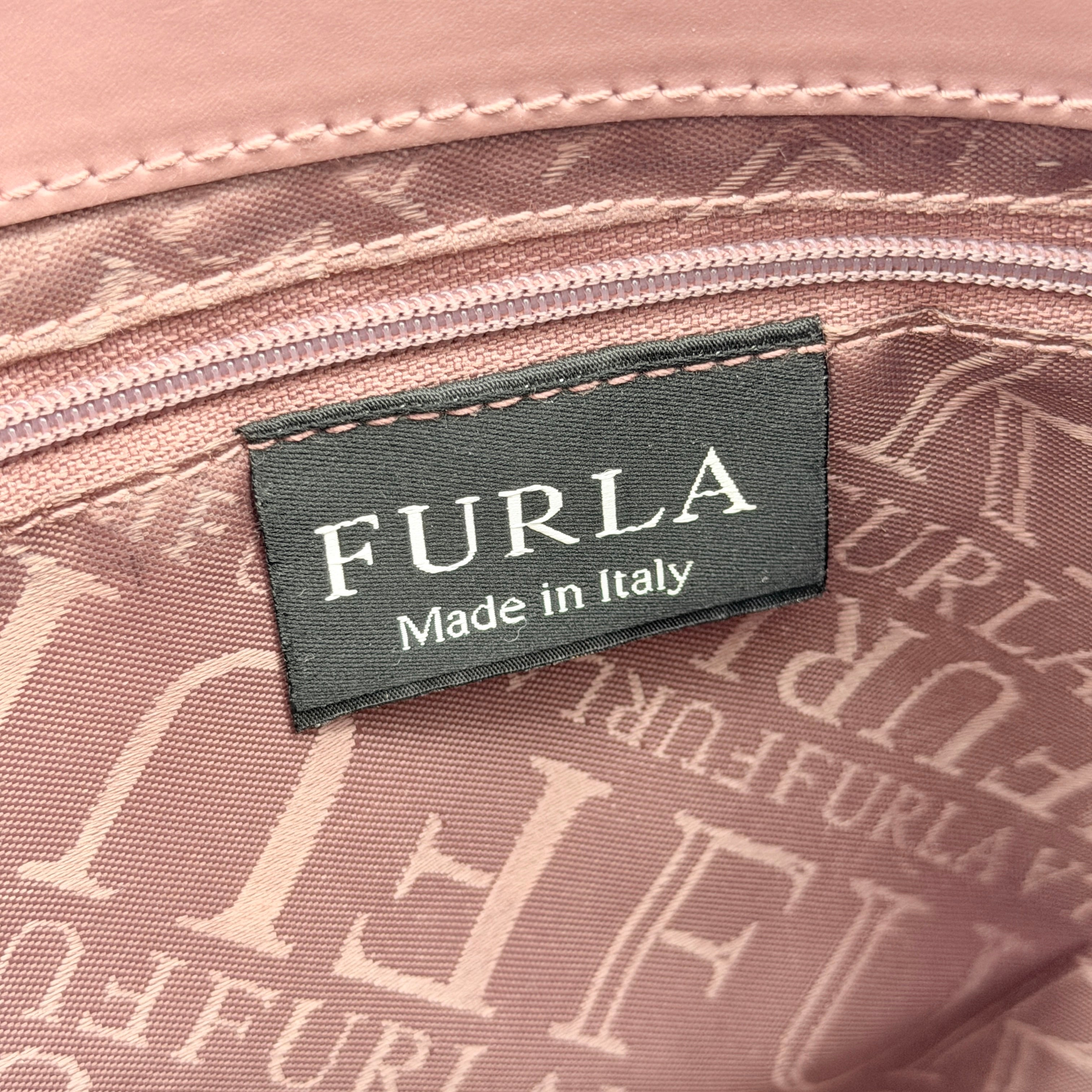 Furla 2Way Leather Handbag in pink with top handles, gold-tone charm, and a detachable strap, photographed on a white background.