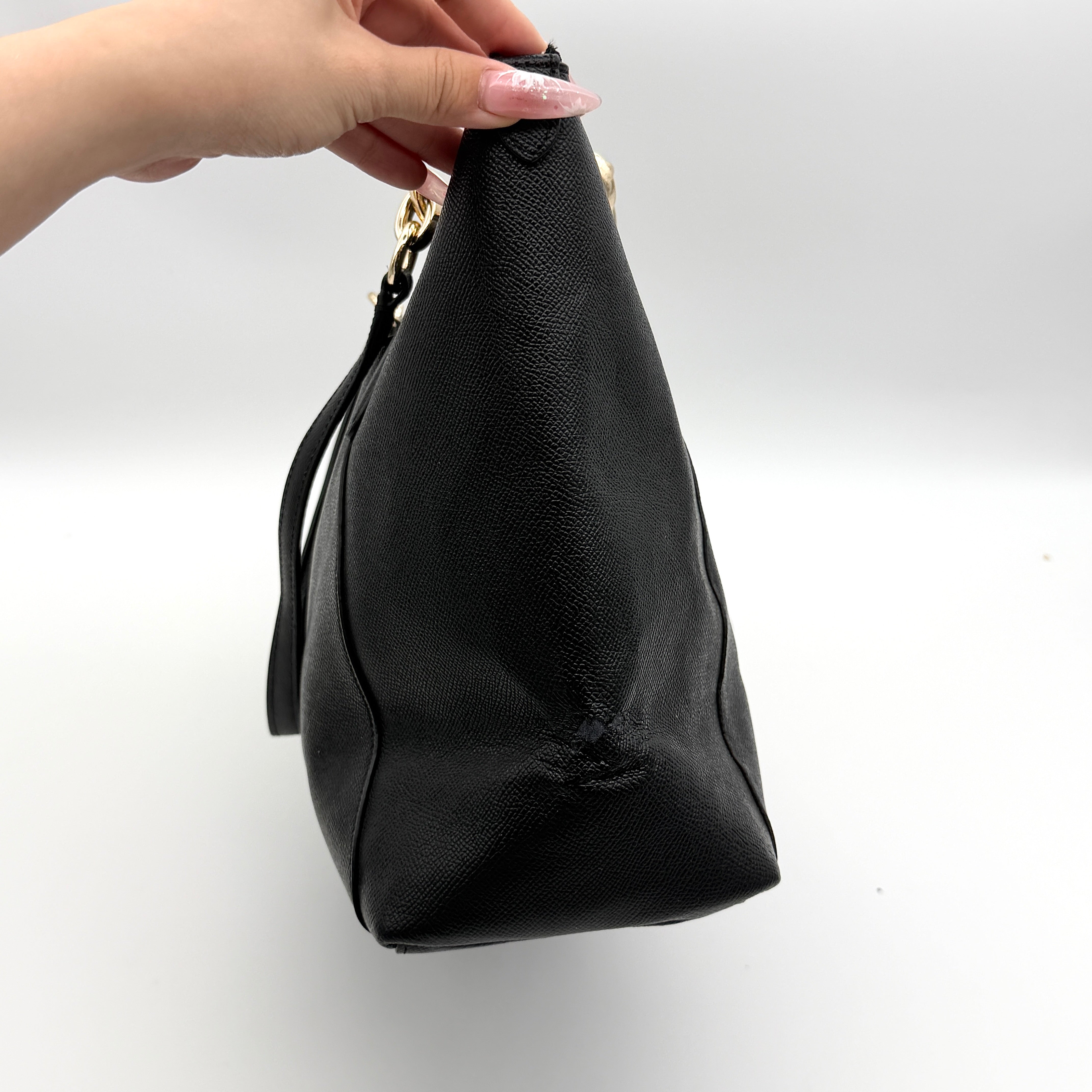Coach Ava Leather Tote Bag in black pebbled leather with gold-tone hardware and dual top handles.