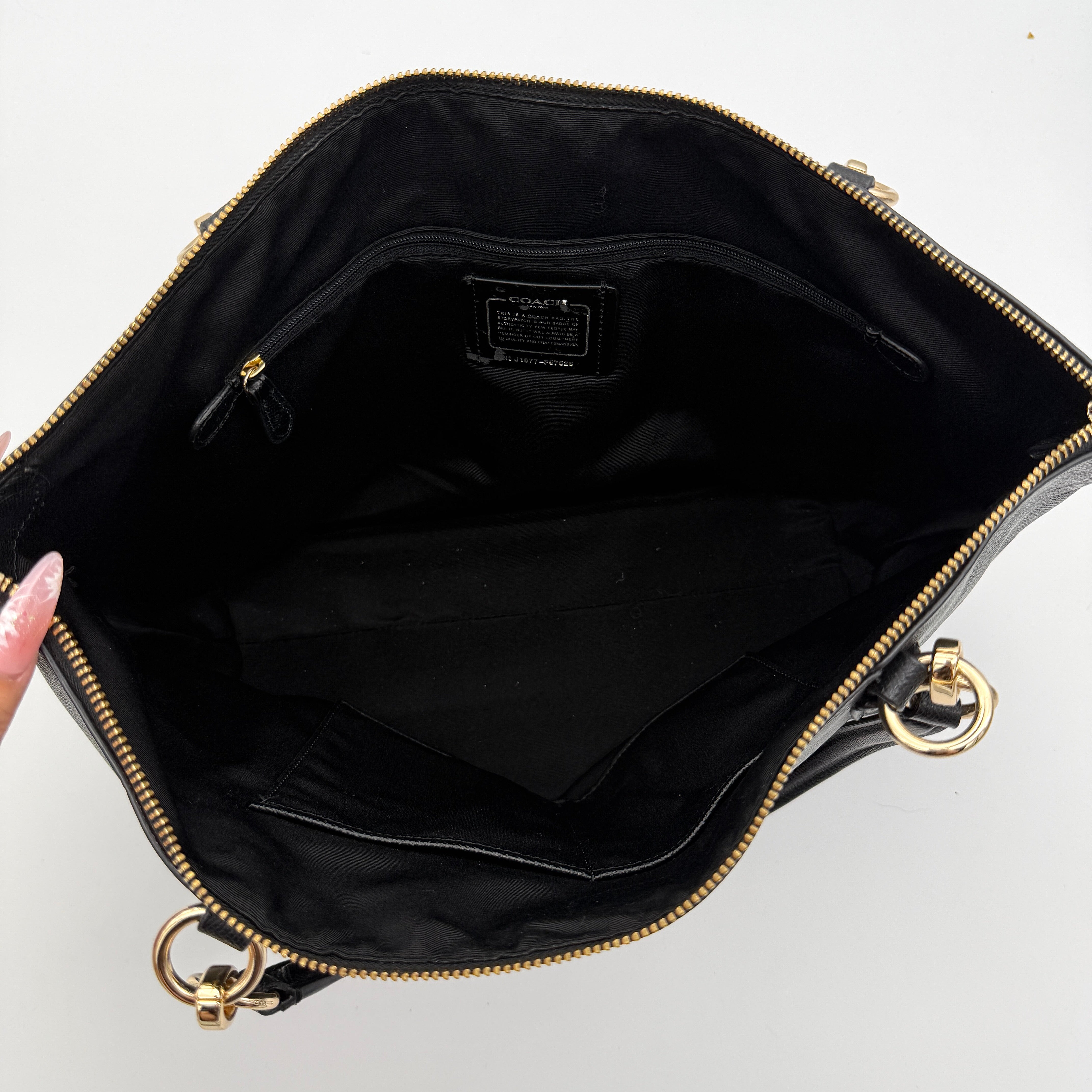 Coach Ava Leather Tote Bag in black pebbled leather with gold-tone hardware and dual top handles.