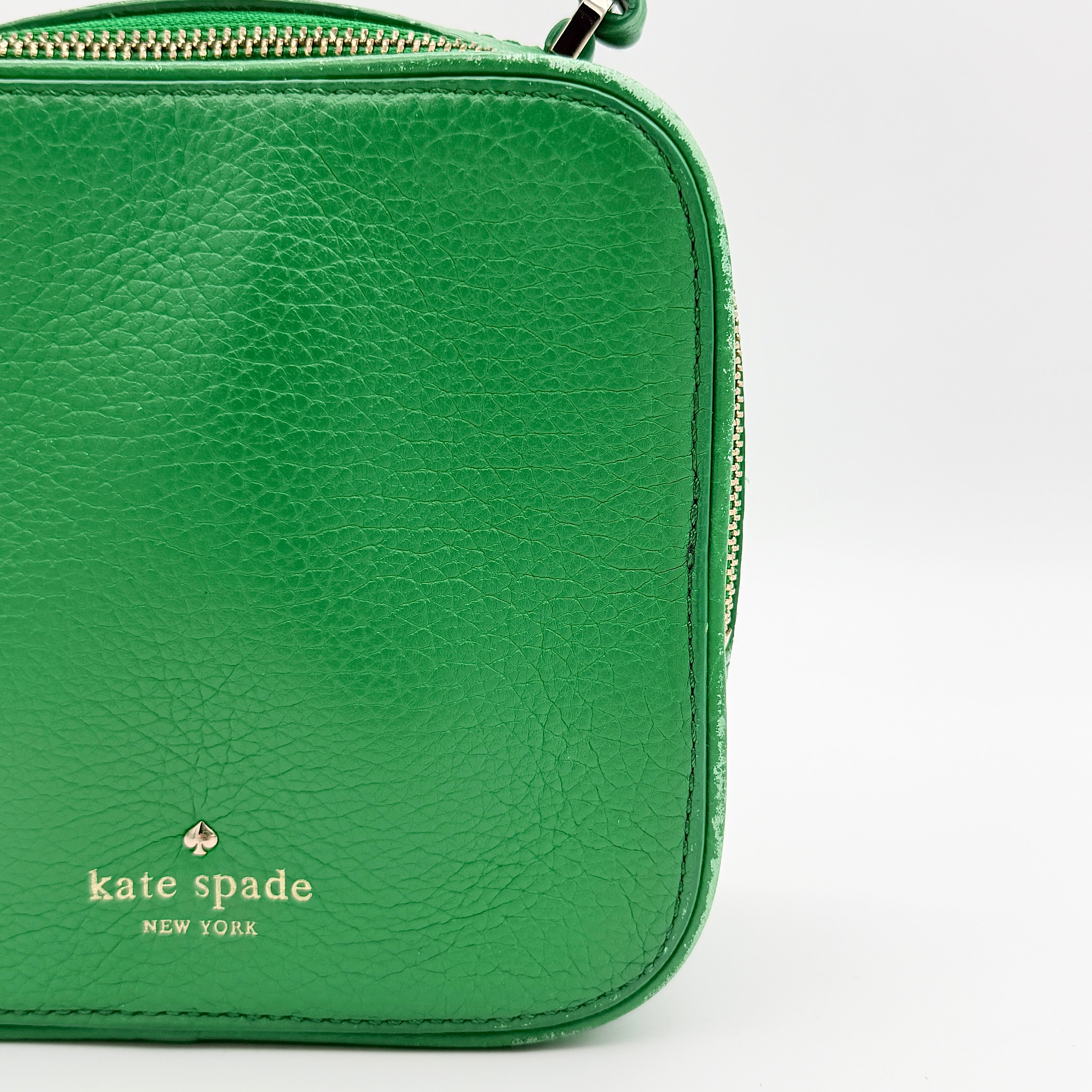 Kate Spade 2Way Vanity Crossbody Bag in bright green pebbled leather with top handle and detachable strap displayed in studio lighting.
