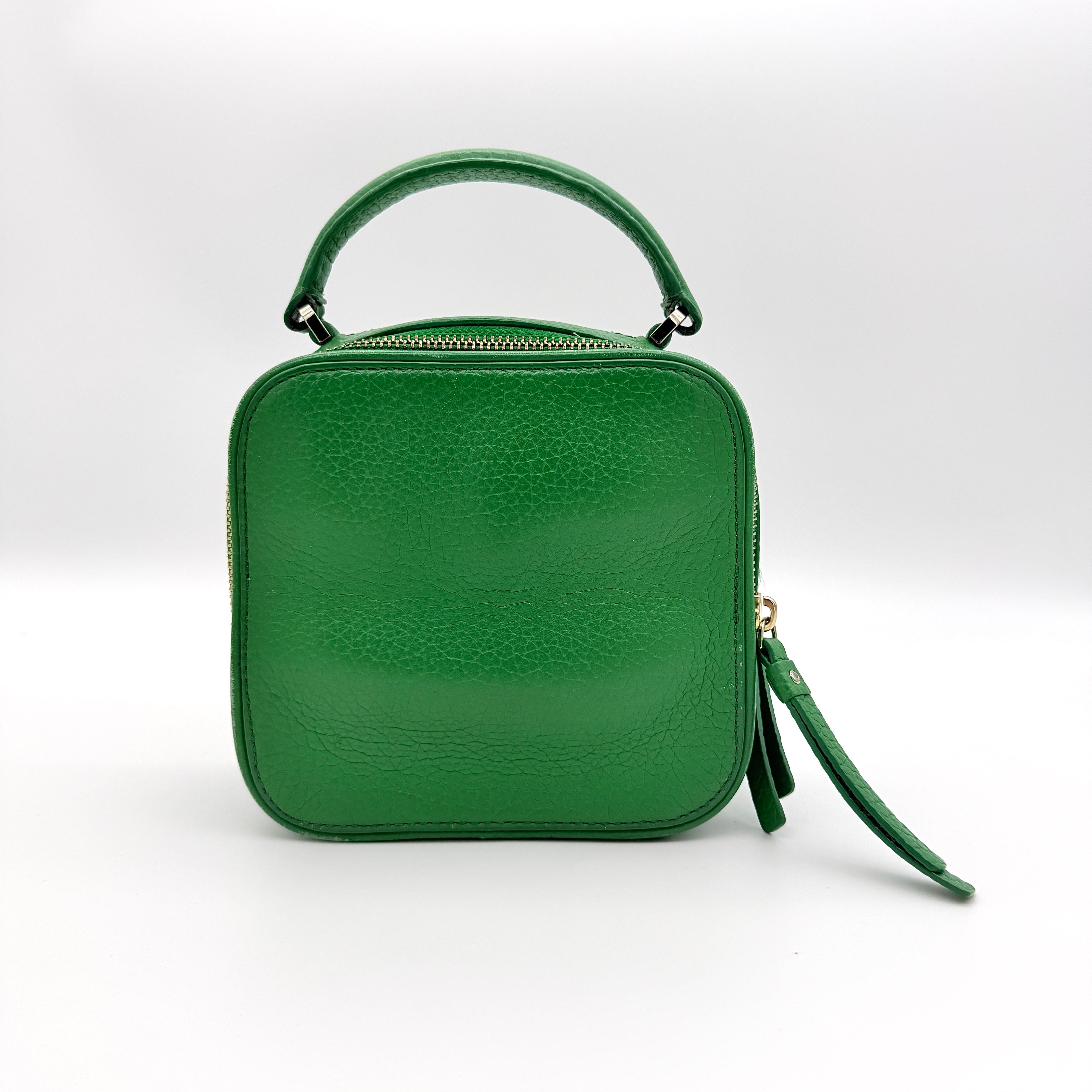 Kate Spade 2Way Vanity Crossbody Bag in bright green pebbled leather with top handle and detachable strap displayed in studio lighting.