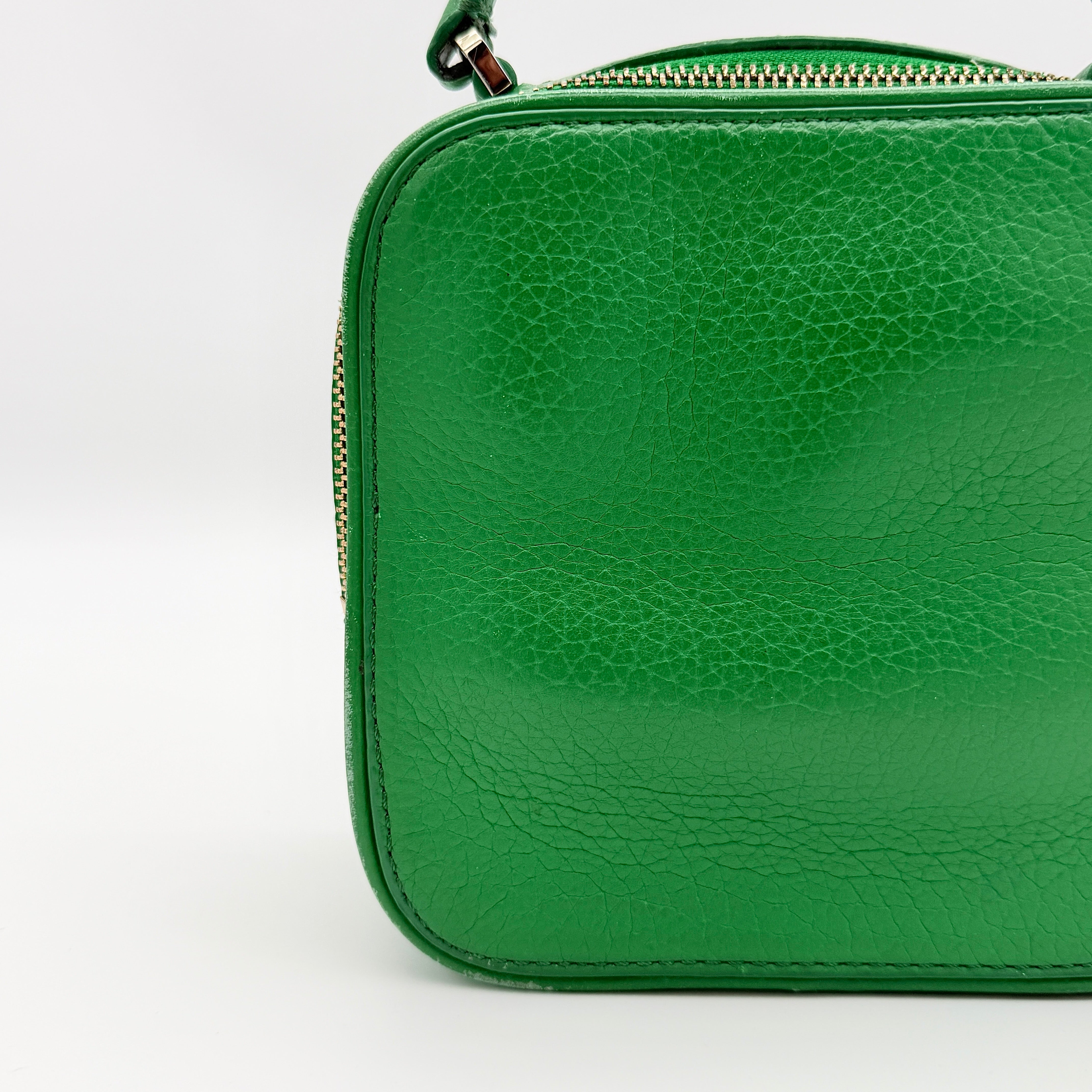 Kate Spade 2Way Vanity Crossbody Bag in bright green pebbled leather with top handle and detachable strap displayed in studio lighting.