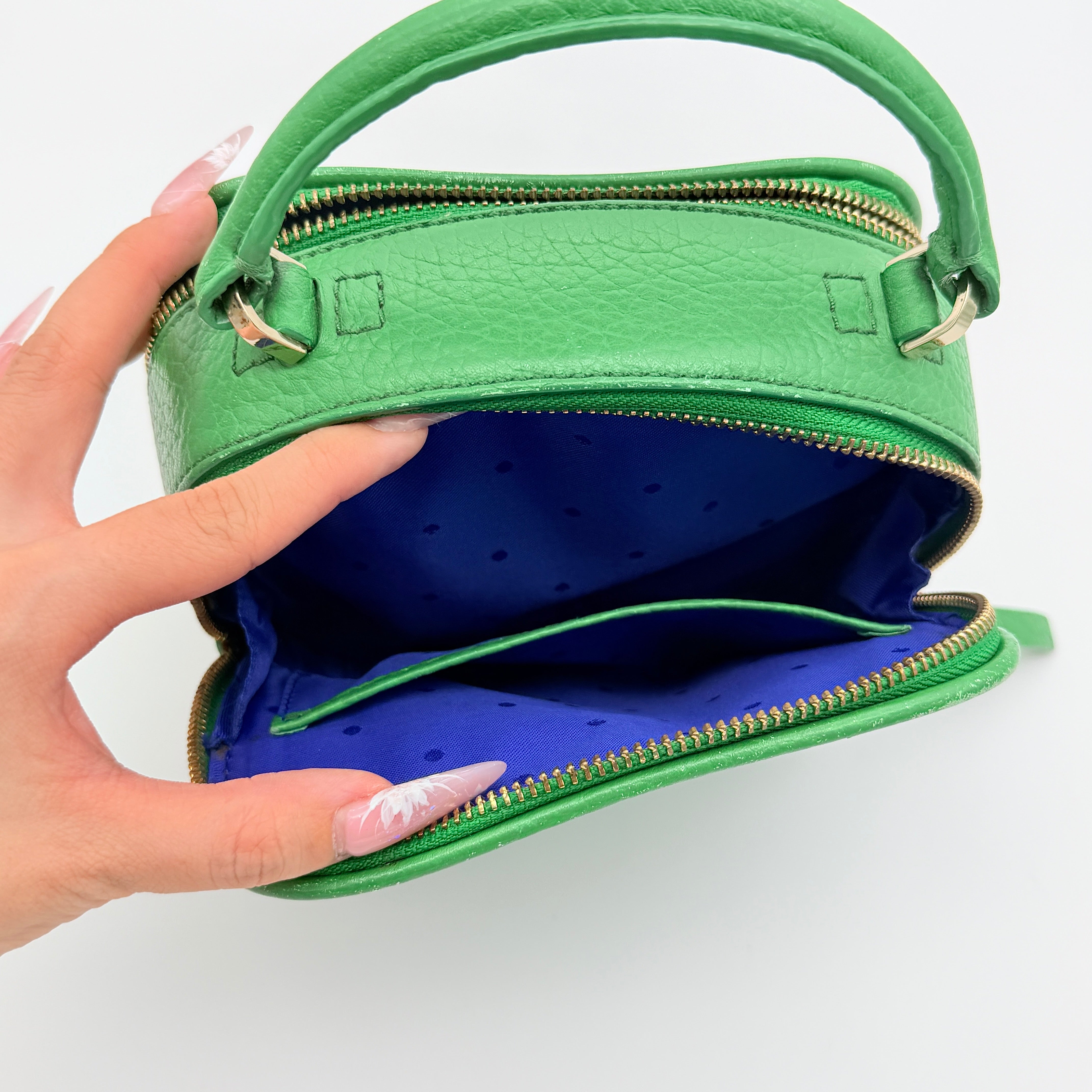 Kate Spade 2Way Vanity Crossbody Bag in bright green pebbled leather with top handle and detachable strap displayed in studio lighting.