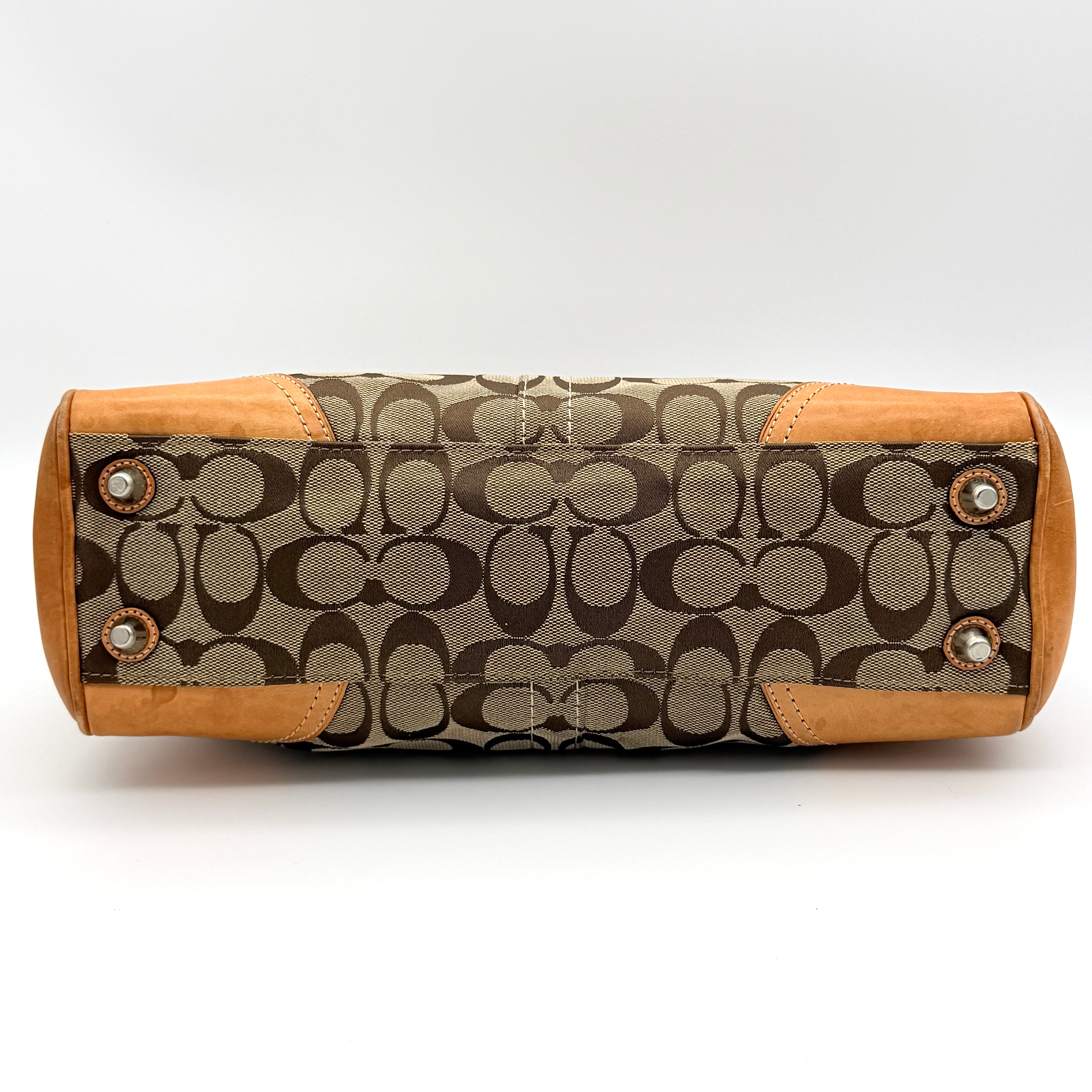 Coach Signature Hampton Carryall shoulder bag in beige monogram canvas and tan leather with silver-tone hardware and double handles.