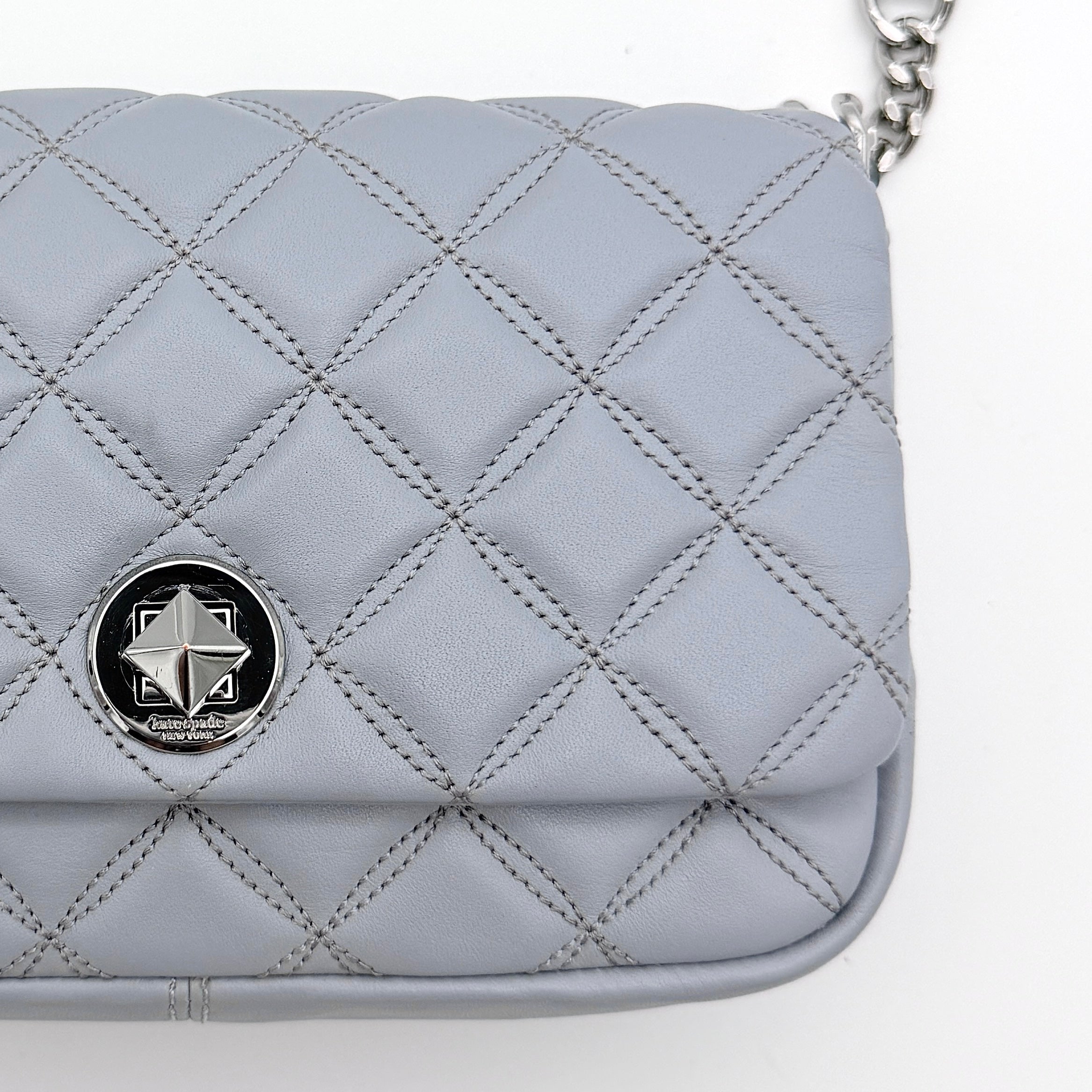 Kate Spade Natalia Flap Crossbody in light blue quilted leather with a silver chain and turn-lock detail.