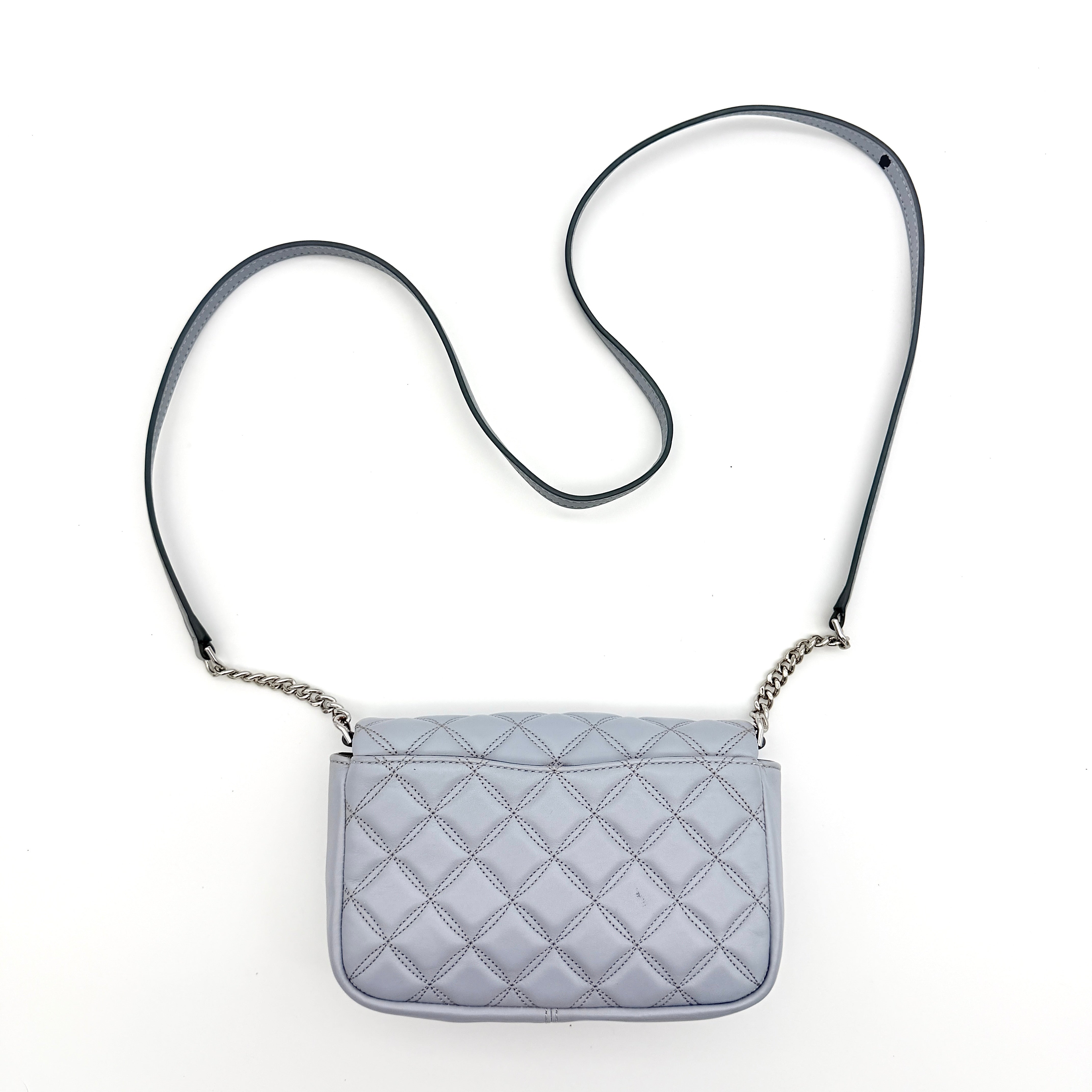 Kate Spade Natalia Flap Crossbody in light blue quilted leather with a silver chain and turn-lock detail.
