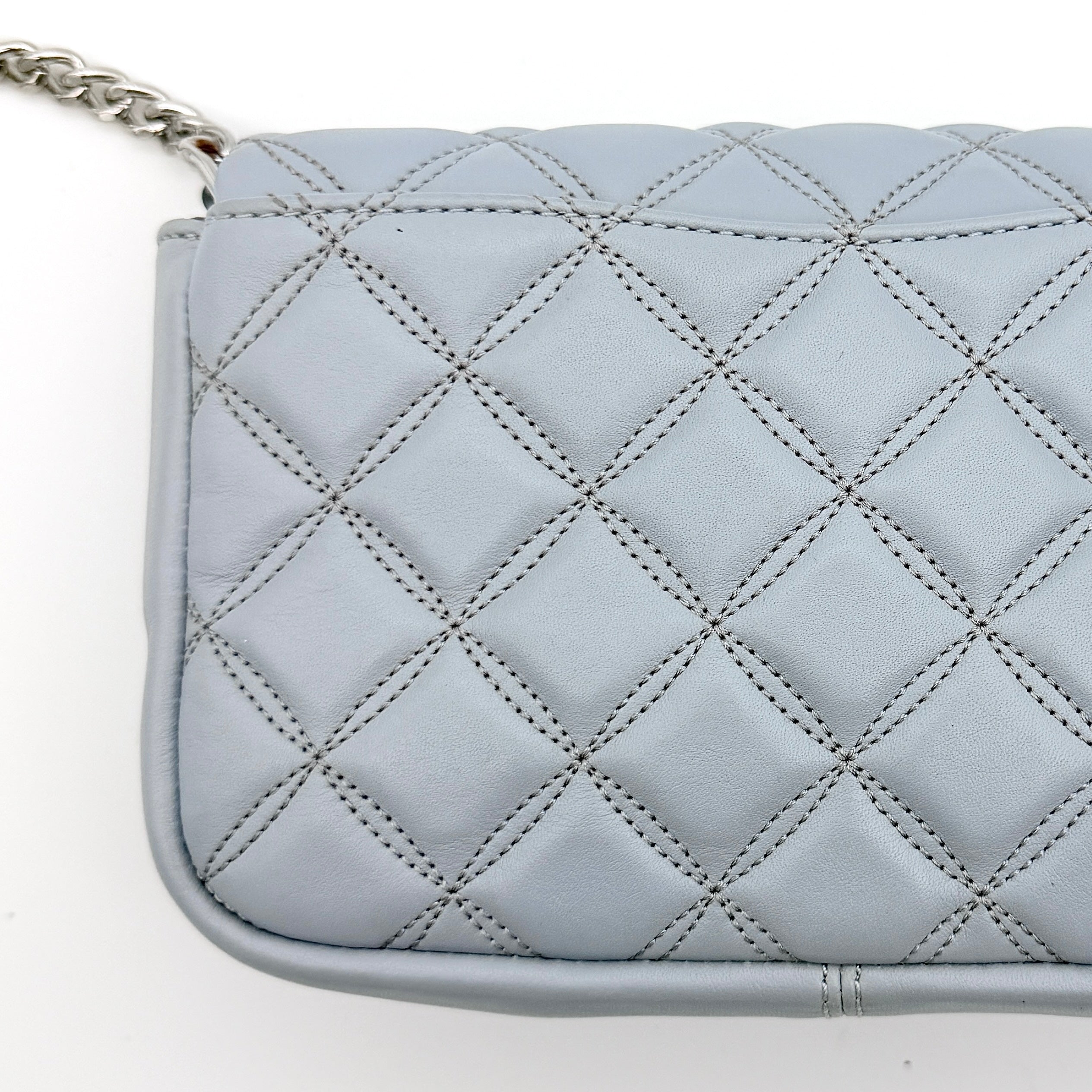 Kate Spade Natalia Flap Crossbody in light blue quilted leather with a silver chain and turn-lock detail.